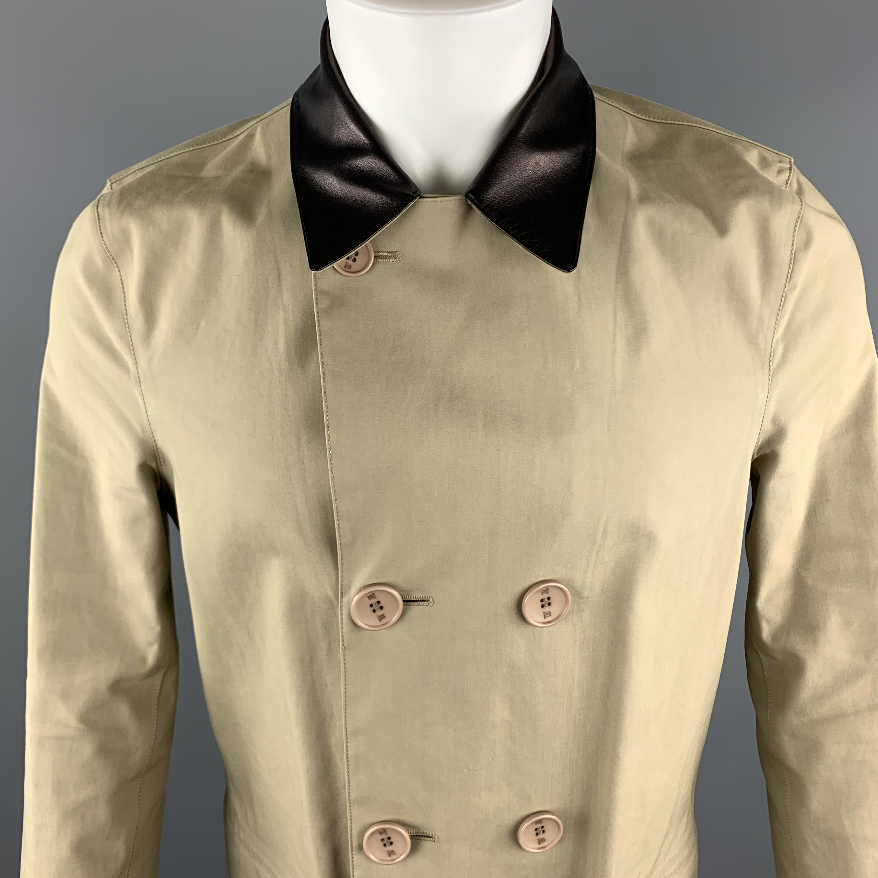BALENCIAGA Coat comes in a khaki coated cotton material, with a leather collar, double breasted, patch pockets, unbuttoned cuffs, unlined. Minor wear. Made in Italy.

Very Good Pre-Owned Condition.
Marked: IT 48

Measurements:

Shoulder: 16 in.