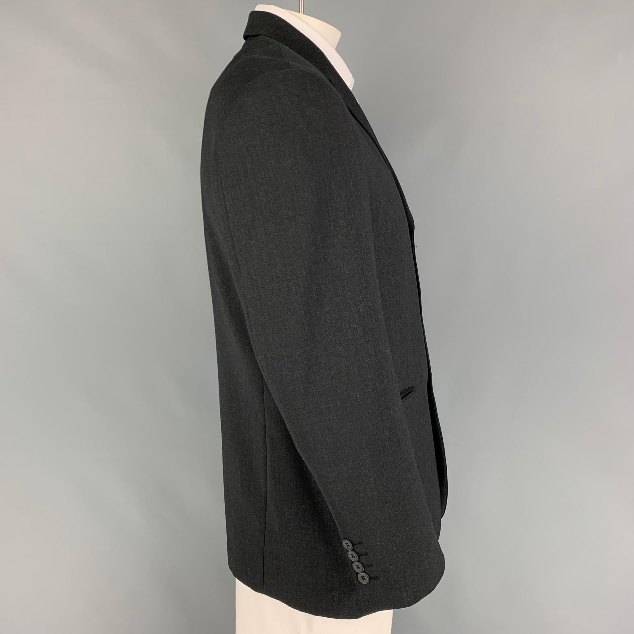 BALENCIAGA sport coat comes in a charcoal wool with a full liner featuring a notch lapel, slit pockets, and a three button closure. 

Very Good Pre-Owned Condition.

Measurements:

Shoulder: 19 in.
Chest: 42 in.
Sleeve: 25 in.
Length: 30.5 in. 