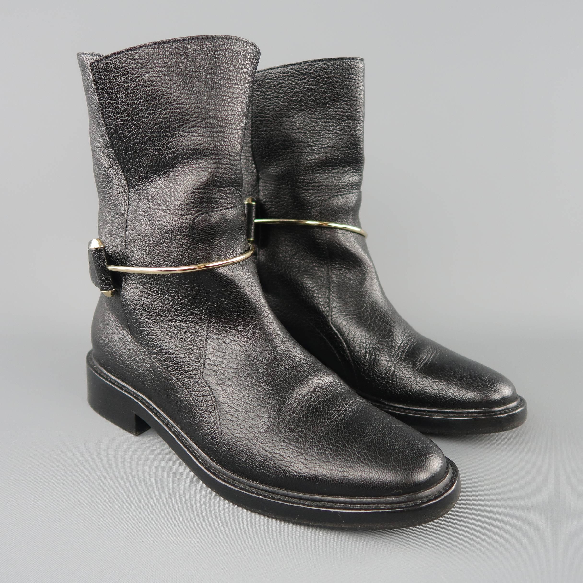 BALENCIAGA by Alexander Wang biker boots come in pebbled leather with a rounded point toe, heeled sole, and gold tone metal bar strap detail. Made in Italy.
 
Excellent Pre-Owned Condition.
Marked: IT 37
 
Measurements:
 
Heel: 1 in.
Length: 8