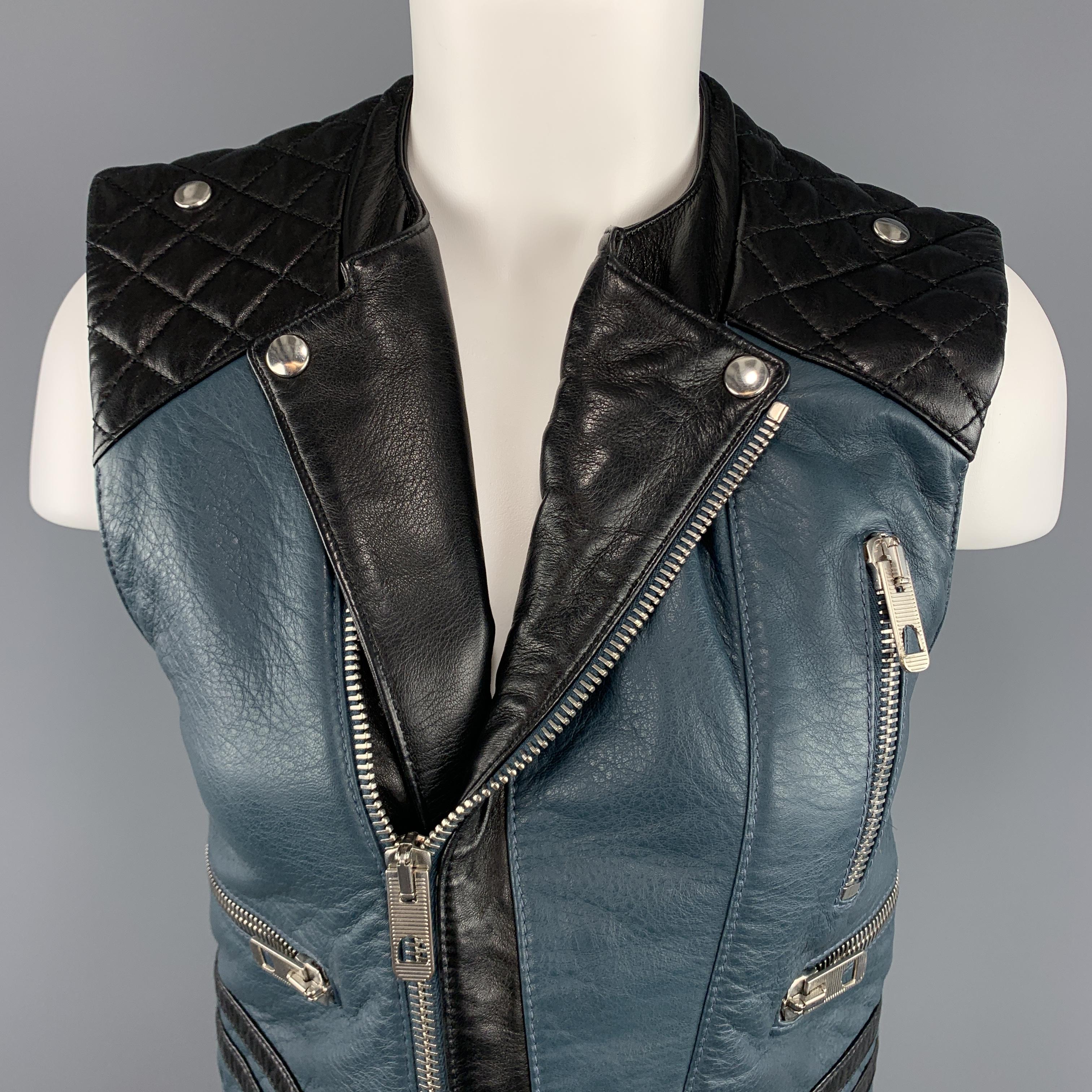 BALENCIAGA.LEATHER biker style moto vest by NICOLAS GHESQUIERE  comes in teal blue textured leather three silver tone zip pockets, asymmetrical zip front, round collarless neckline with pointed lapel, black quilted leather shoulders, and black