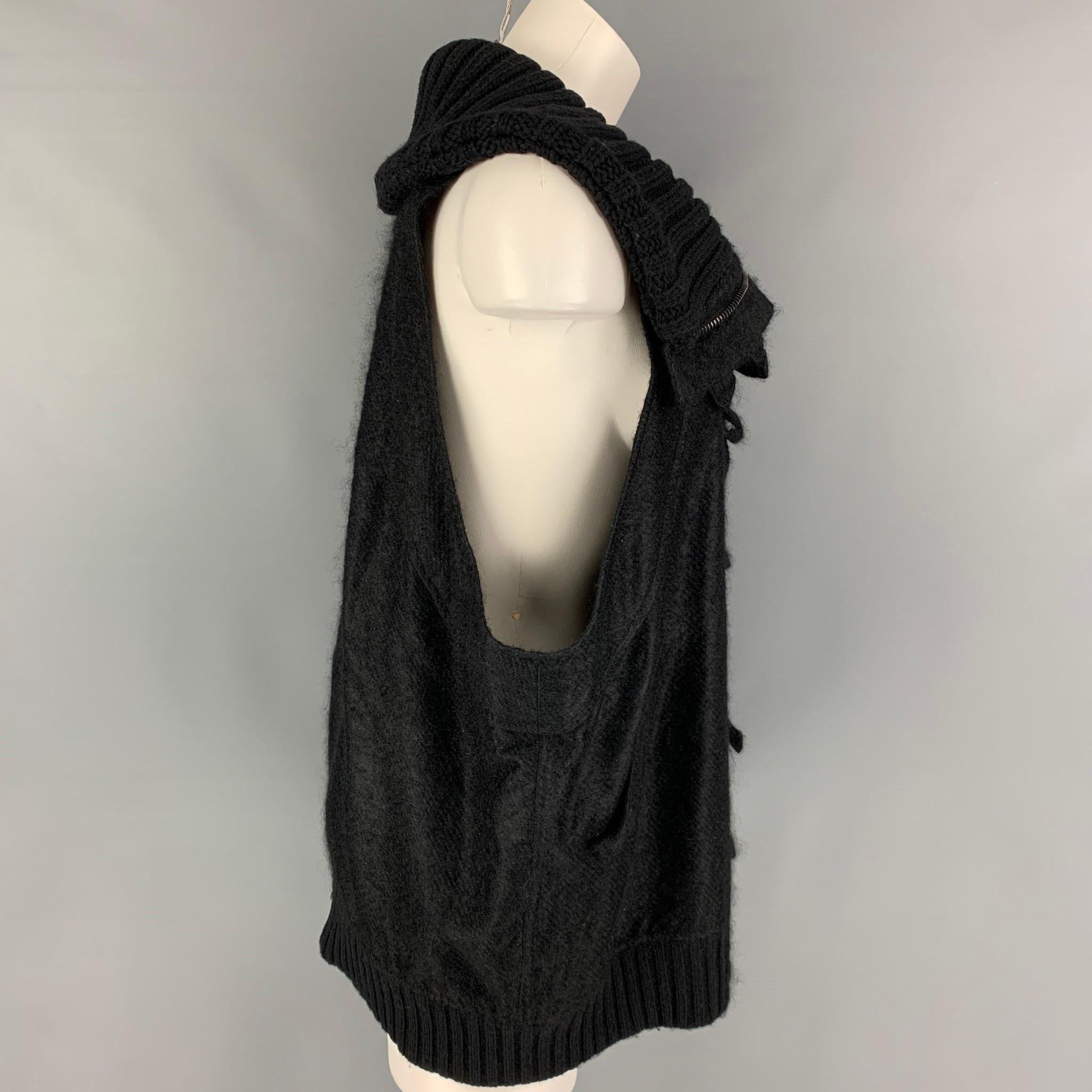 BALENCIAGA vest comes in a black mohair blend featuring a oversized fit, large knitted collar, slit pockets, and a zip & buttoned closure. 

Very Good Pre-Owned Condition.
Marked: 36

Measurements:

Shoulder: 12 in.
Bust: 52 in.
Length: 28 in.