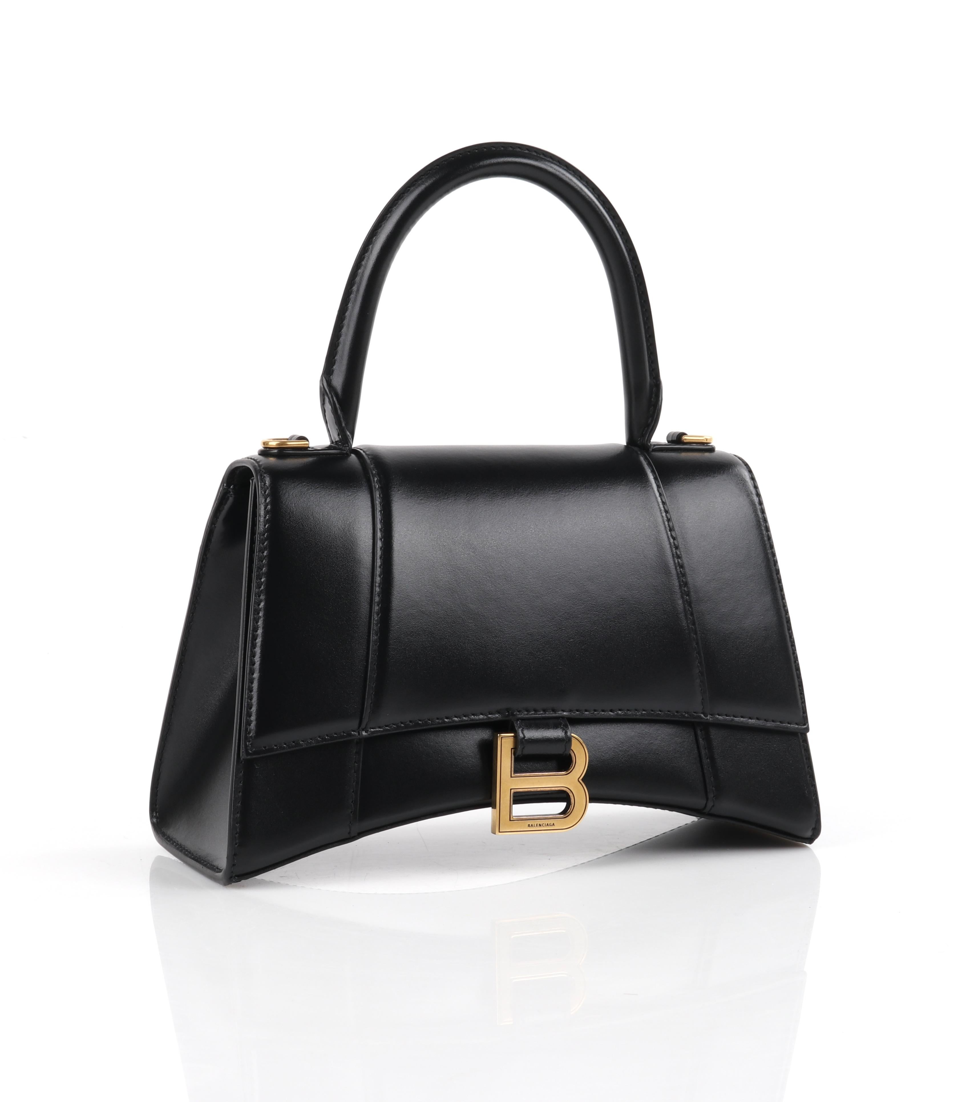 BALENCIAGA Small Black Shiny Calfskin Gold Brass Hardware “Hourglass” Handle Bag
 
Brand / Manufacturer: Balenciaga
Manufacturer Style Name: Hourglass Small Top Handle Bag
Style: Handbag
Color(s): Shades of black and gold
Lined: No
Marked Fabric