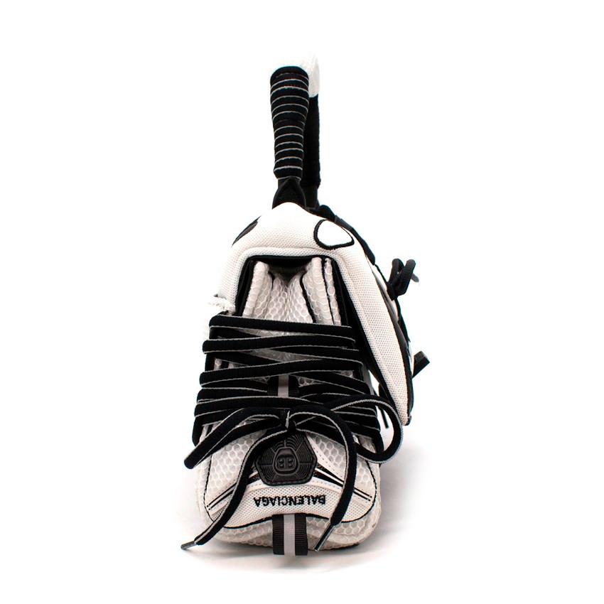 Balenciaga Sneakerhead Small Mesh & Leather Hourglass Bag

- 'Hourglass' tote shape
- Overlaid with details from the label's 'Track' sneakers
- White mesh base
- Black leather overlays 
- Lace-up front
- Magnetic closure topped with a 'B' emblem 
-