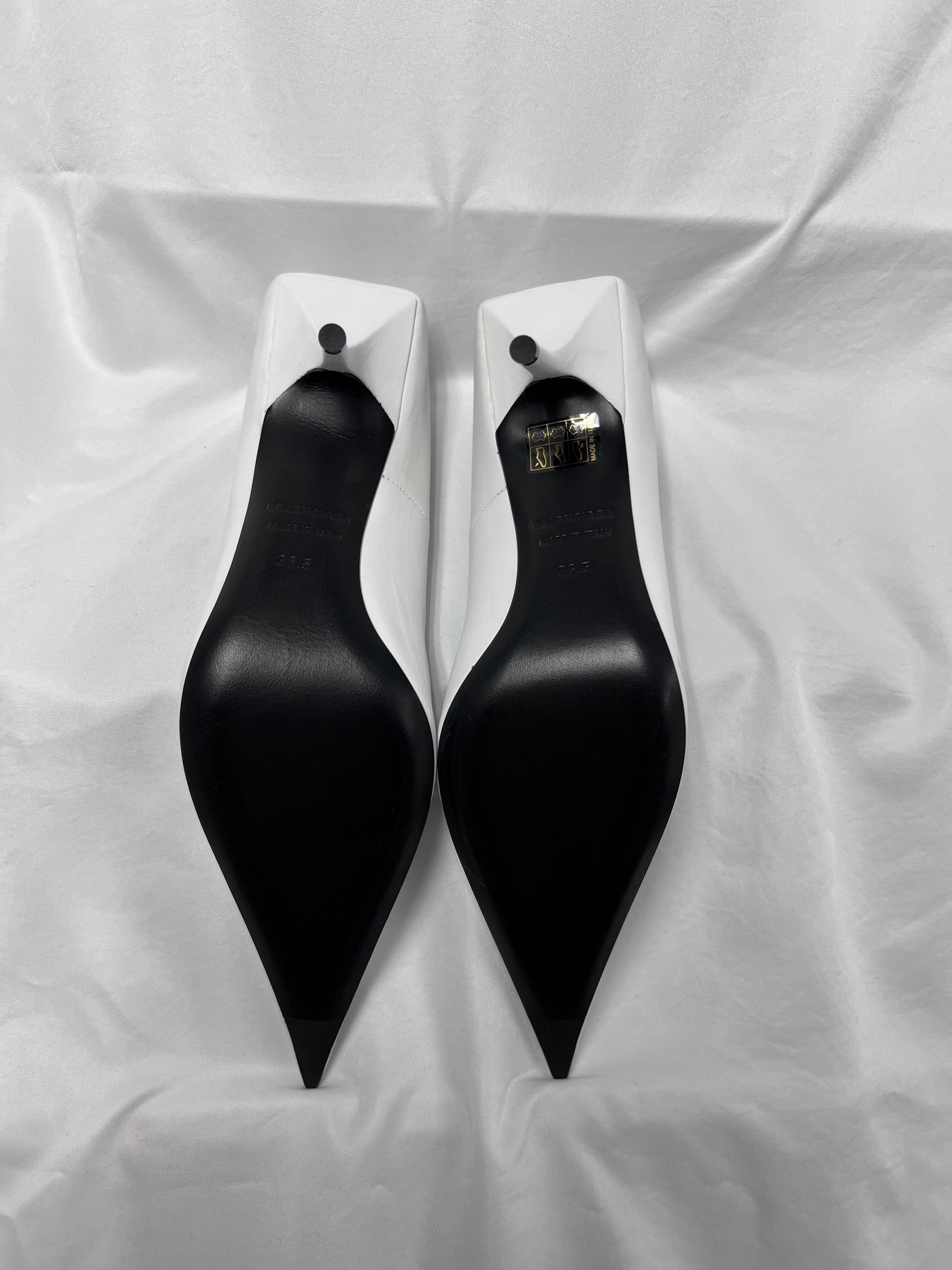 Refined and striking, these Balenciaga Square Knife pumps are crafted from luxurious white nappa leather with a smooth, polished finish. Their streamlined silhouette is accentuated by pin-thin stiletto heels, pointed toes, and distinctive square