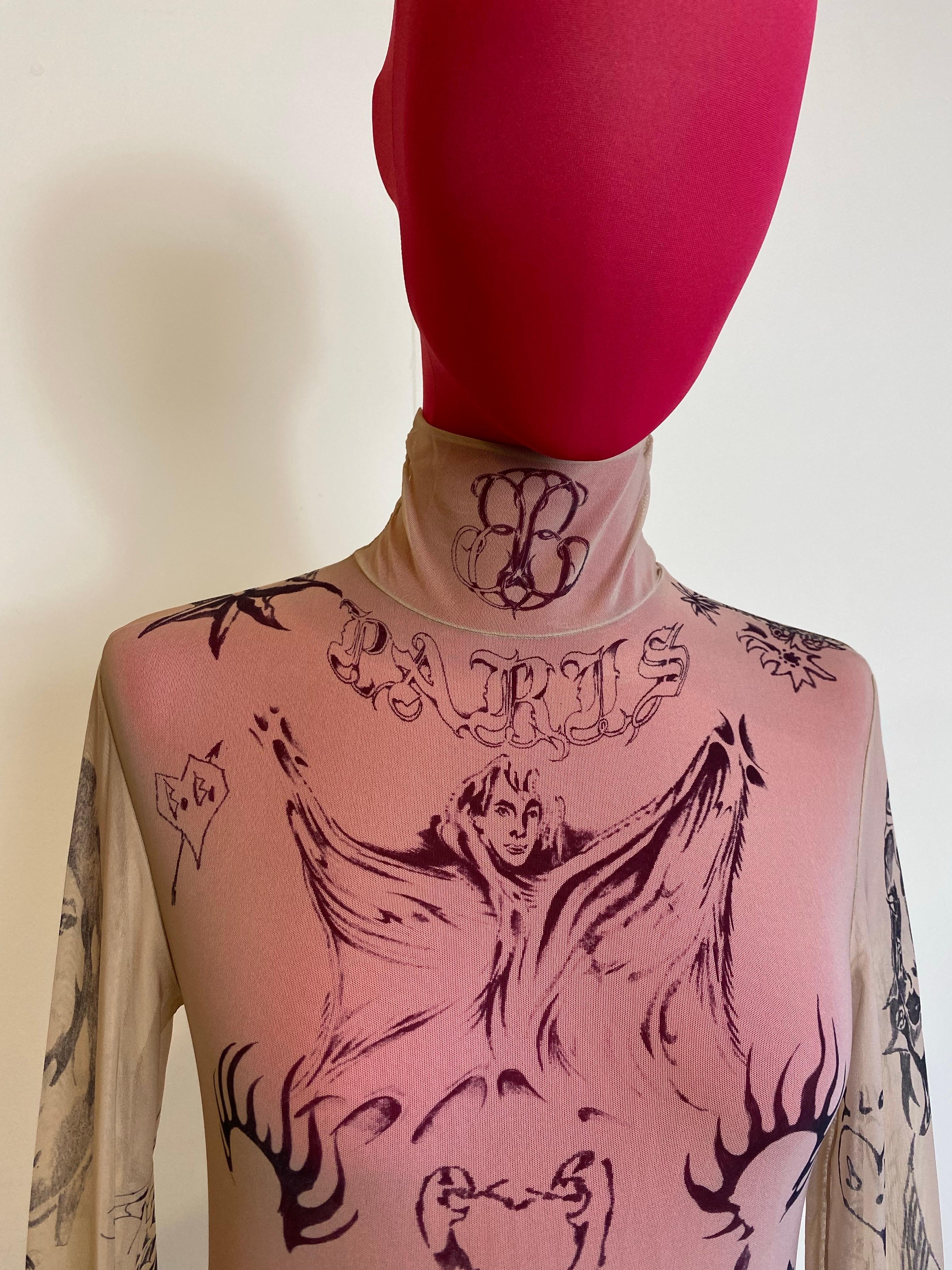 Balenciaga Tattoo Top. SS 2024 Collection. Missing composition label but we think it is polyamide and elastane. Missing size label but fits an international S. Shoulders 40 cm Bust 38 cm Length 65 cm New with tag. However, it has a small hole on the