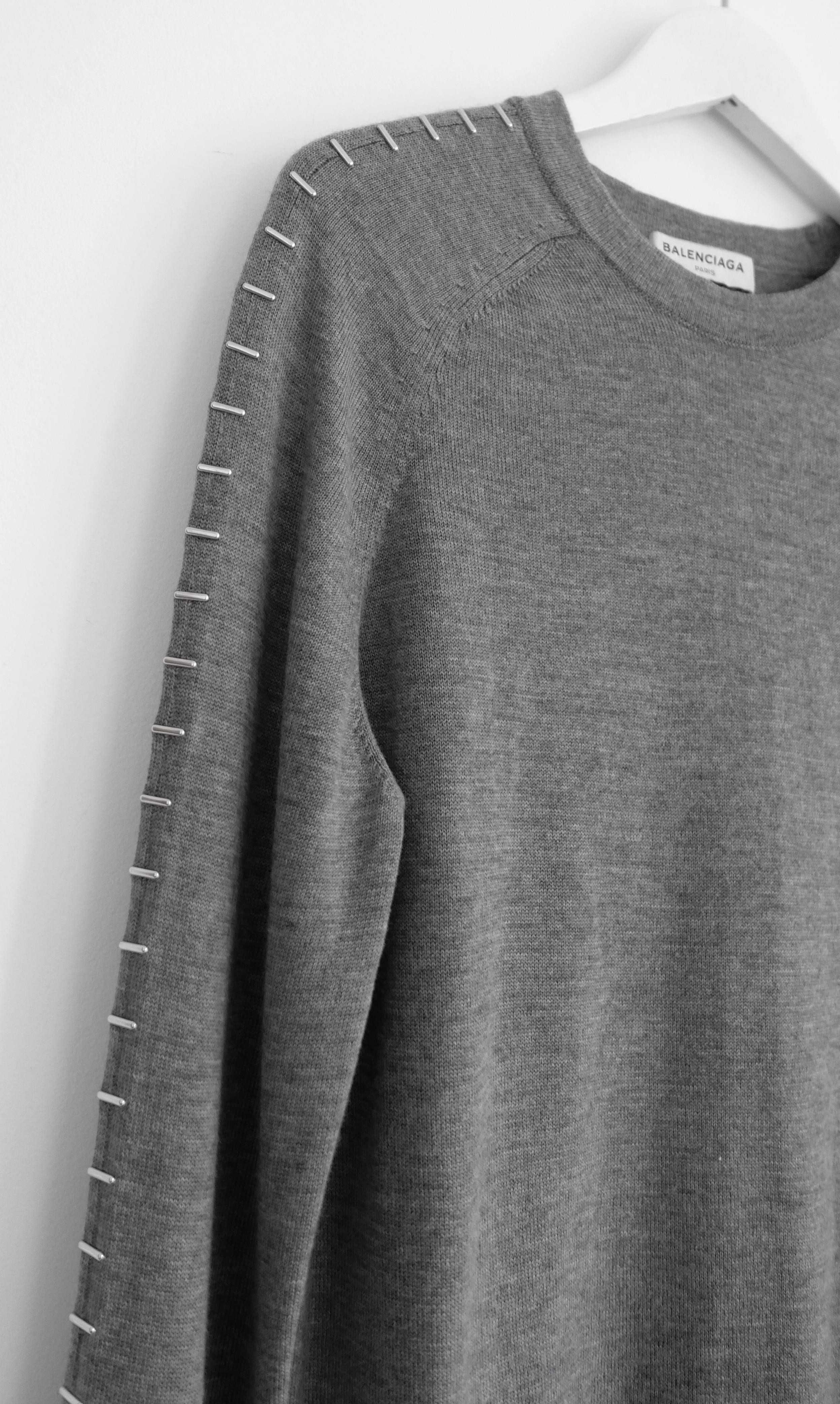 Super cool Balenciaga staple trim fine knit jumper. Made from a smooth, fine knit grey wool with silvertone staple inspired sleeve embellishments. Worn once. Missing size/comp label but will fit a M. Measures un-stretched approx - bust 34”, waist