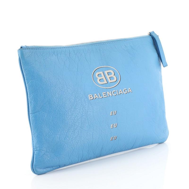 This Balenciaga Supermarket Pouch Leather Medium, crafted from blue leather, features front Balenciaga EU print and silver tone hardware. Its zip closure opens to a black fabric interior with slip pocket. 

Estimated Retail Price: $650
Condition: