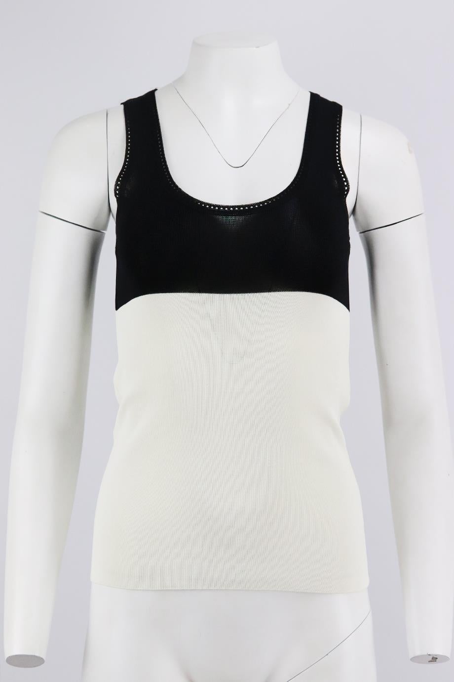 Balenciaga two tone stretch knit top. Black and white. Sleeveless, crewneck. 100% Rayon. Size: FR 34 (UK 6, US 2, IT 38). Bust: 25 in. Waist: 24 in. Hips: 27 in. Length: 21 in. Very good condition - No sign of wear; see pictures.
