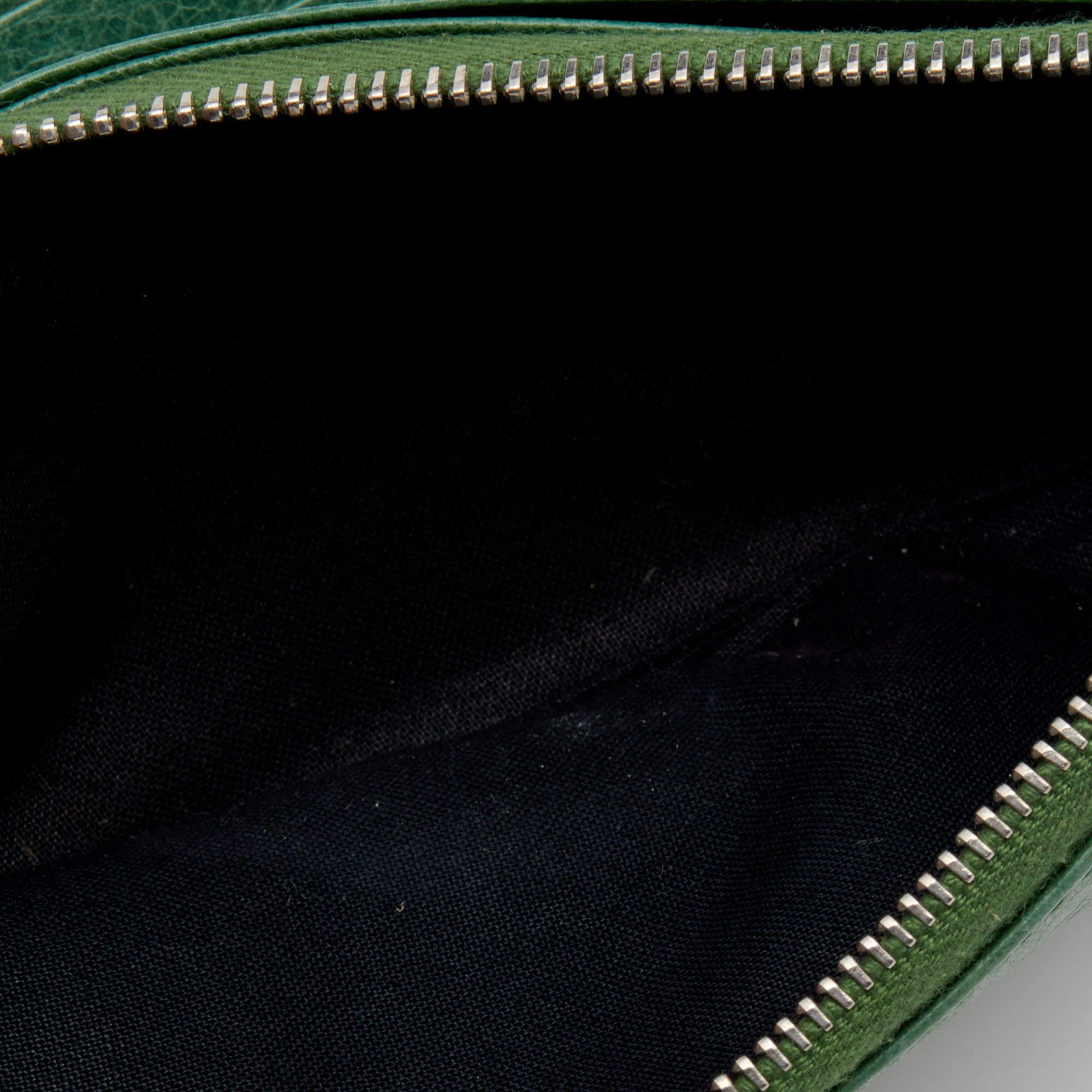 The silver tone studs decorate the leather exterior of this Balenciaga wallet. It flaunts a front zipper pocket and its fabric lined interior is divided into different compartments to dutifully hold your monetary essentials.
