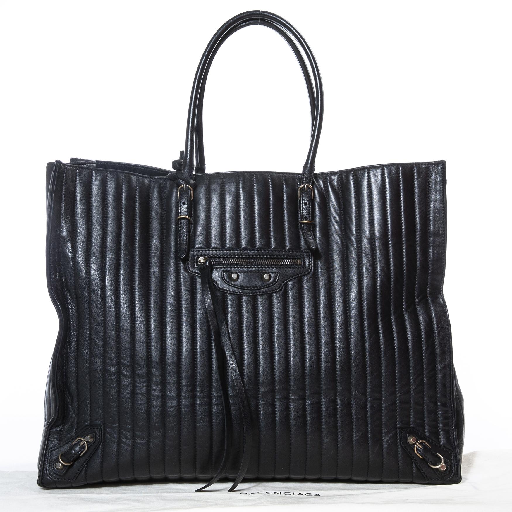 Very good condition

Balenciaga Vertical Quilted Black Papier A4 Tote

This gorgeous bag by Balenciaga is crafted from black vertical quilted leather, which gives the bag a unique look!
It features aged gold-tone hardware, including the iconic