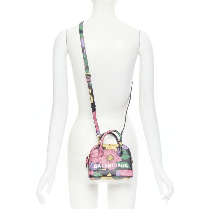 BALENCIAGA Ville XXS black floral logo print top handle crossbody bag
Reference: TGAS/B01535
Brand: Balenciaga
Designer: Demna
Model: Ville XXS
Material: Leather
Color: Multicolour
Pattern: Floral
Closure: Zip
Lining:  Leather
Extra Details: Ville