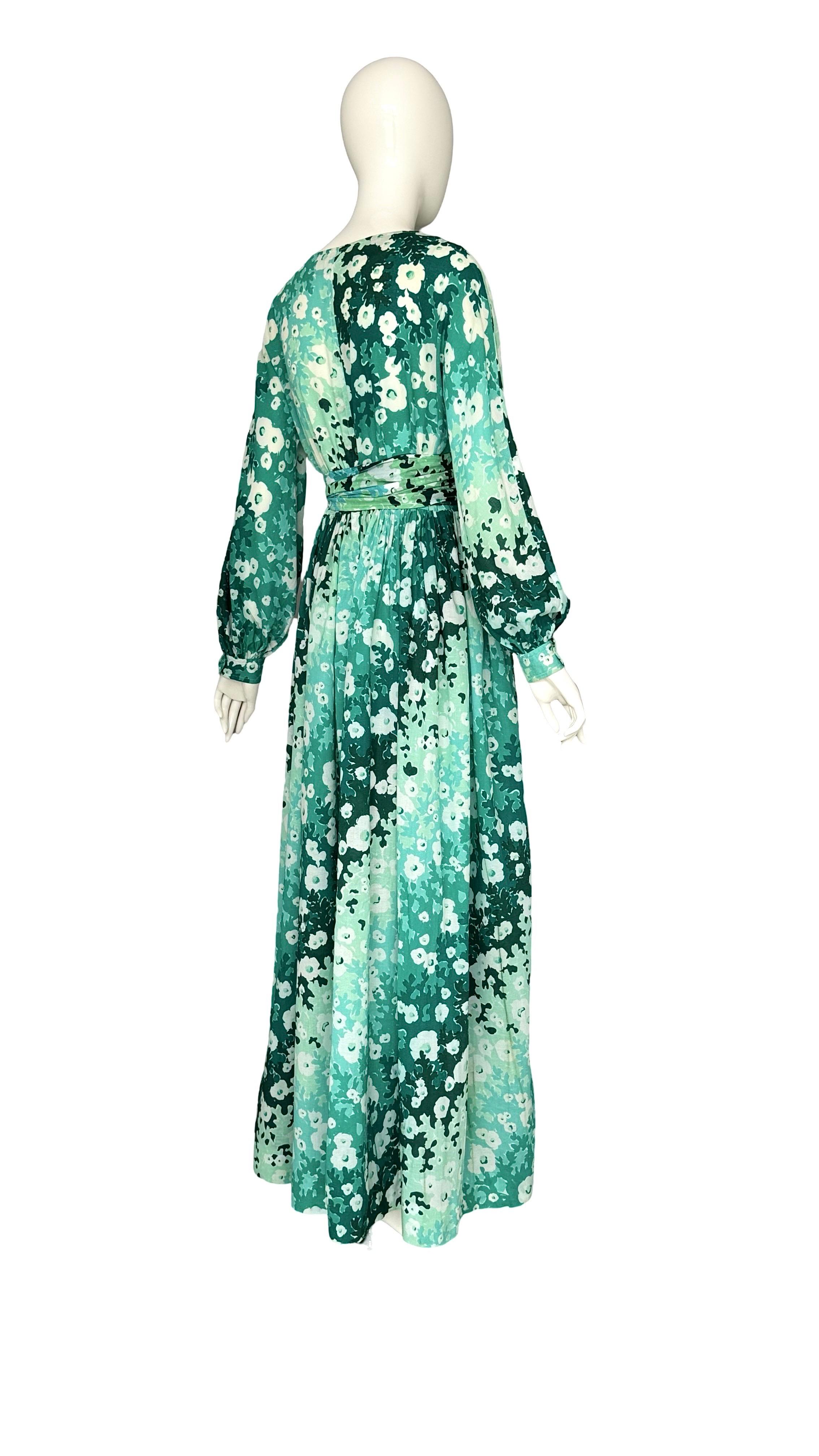 Balenciaga Vintage 1980s Green Floral Print Boho Dress Made In A Cotton & Silk Blend.

A stunning vintage Balenciaga boho dress from the 1980s, featuring a beautiful green floral print. Crafted from a luxurious cotton-silk blend crepe fabric, it