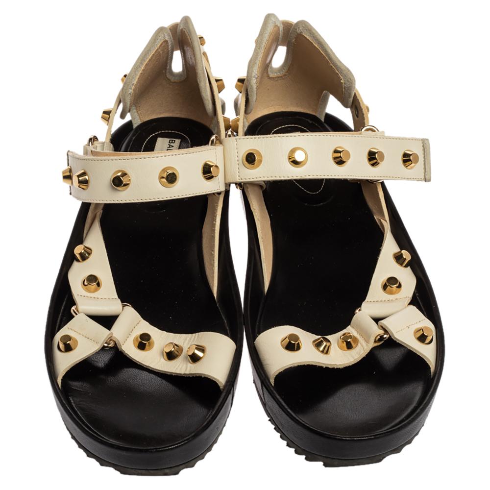 For days of comfort, slip on these platform sandals by Balenciaga. Made from white leather, they are designed with metal studs on the vamp straps and adjustable ankle straps. The insoles are leather-lined and stamped with the label. Keep your style