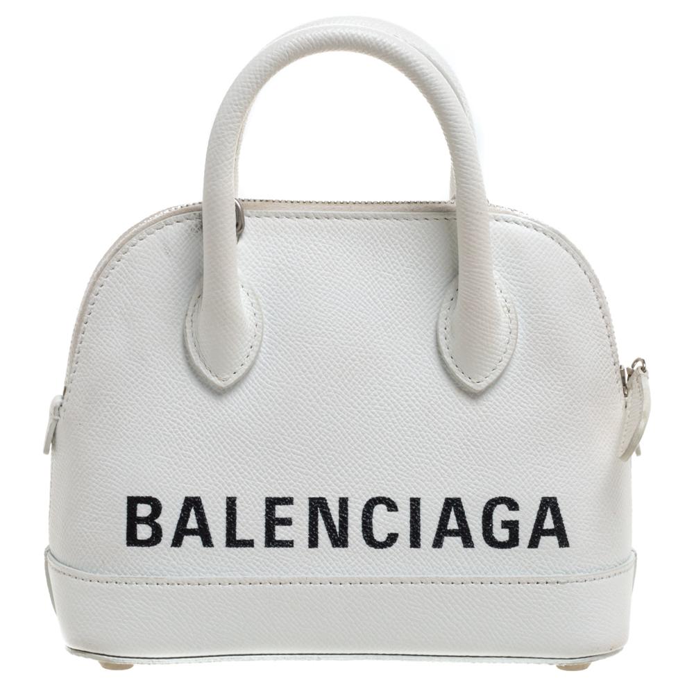 Quite trendy and extremely stylish, this Balenciaga XXS Ville bag is one you must definitely get your hands on! The white creation comes crafted from leather and detailed with the brand logo on the front and back. It has dual top handles and a zip