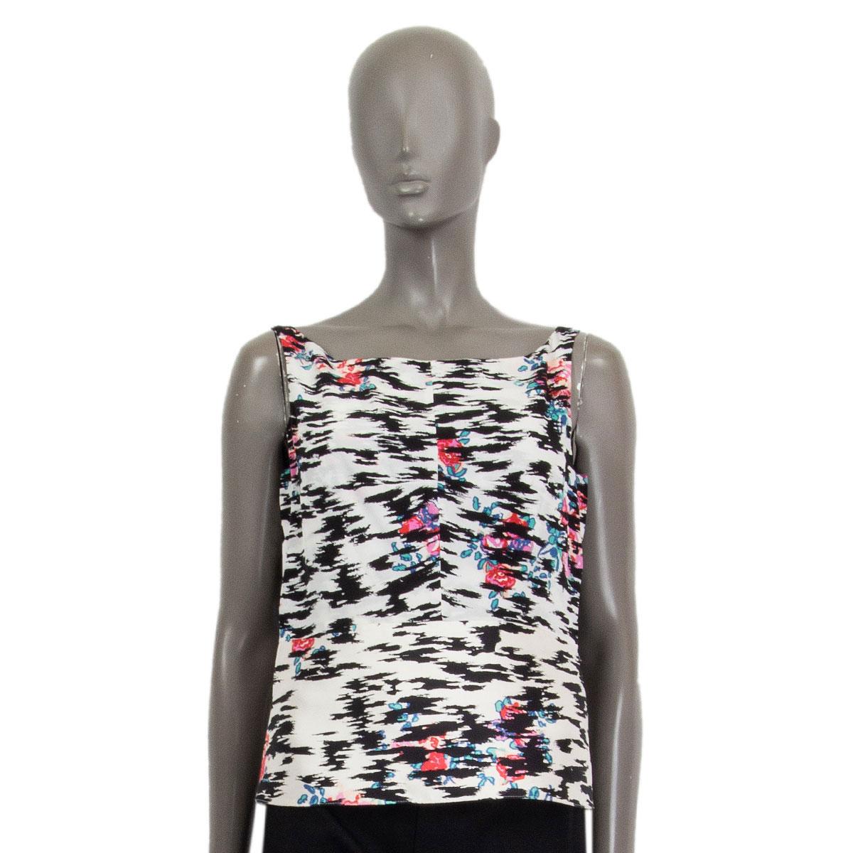 100% authentic Balenciaga sleeveless blouse in white, off-white, black, red, pink, blue and turquoise rose printed silk (100%). Bottom half has interior facing which makes it stiffer and structured. Hidden zipper starts at bottom hem and zips