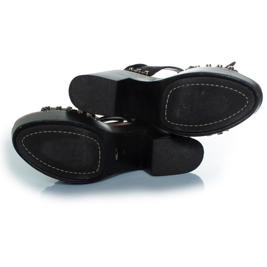 Balenciaga, Wooden and leather clog lace up sandals. The item is in very good condition. 

CONDITION: very good condition

SIZE: 41

INSOLE MEASUREMENTS: 27 cm

HEEL MEASUREMENTS: 11 cm PLATFORM: 5 cm

FABRIC: leather, wood

COLOUR: black