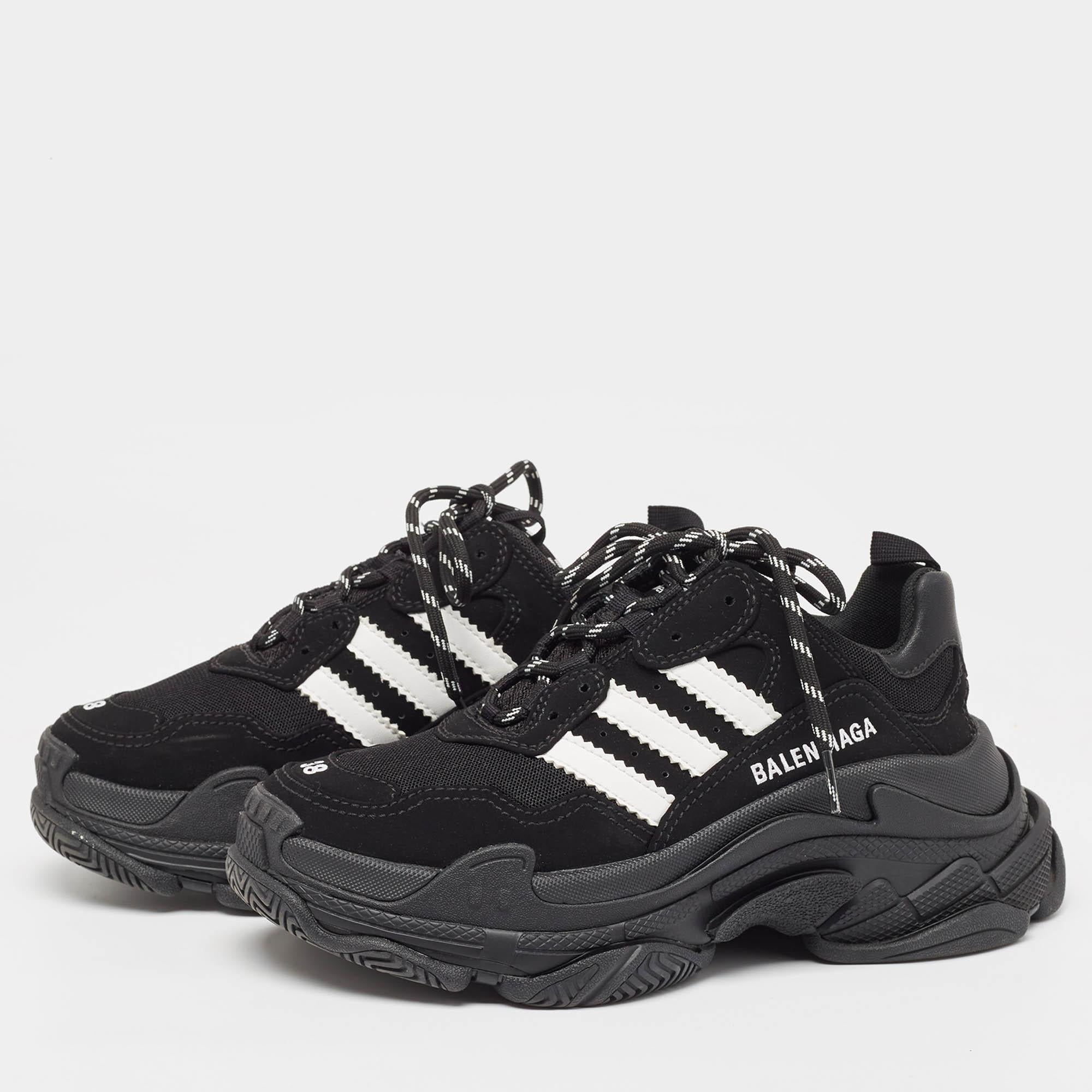 Balenciaga x Adidas Triple S Sneakers combine striking design with premium materials. These stylish shoes feature a bold black and white color scheme faux leather overlays and breathable mesh panels. Their chunky silhouette and iconic Triple S sole