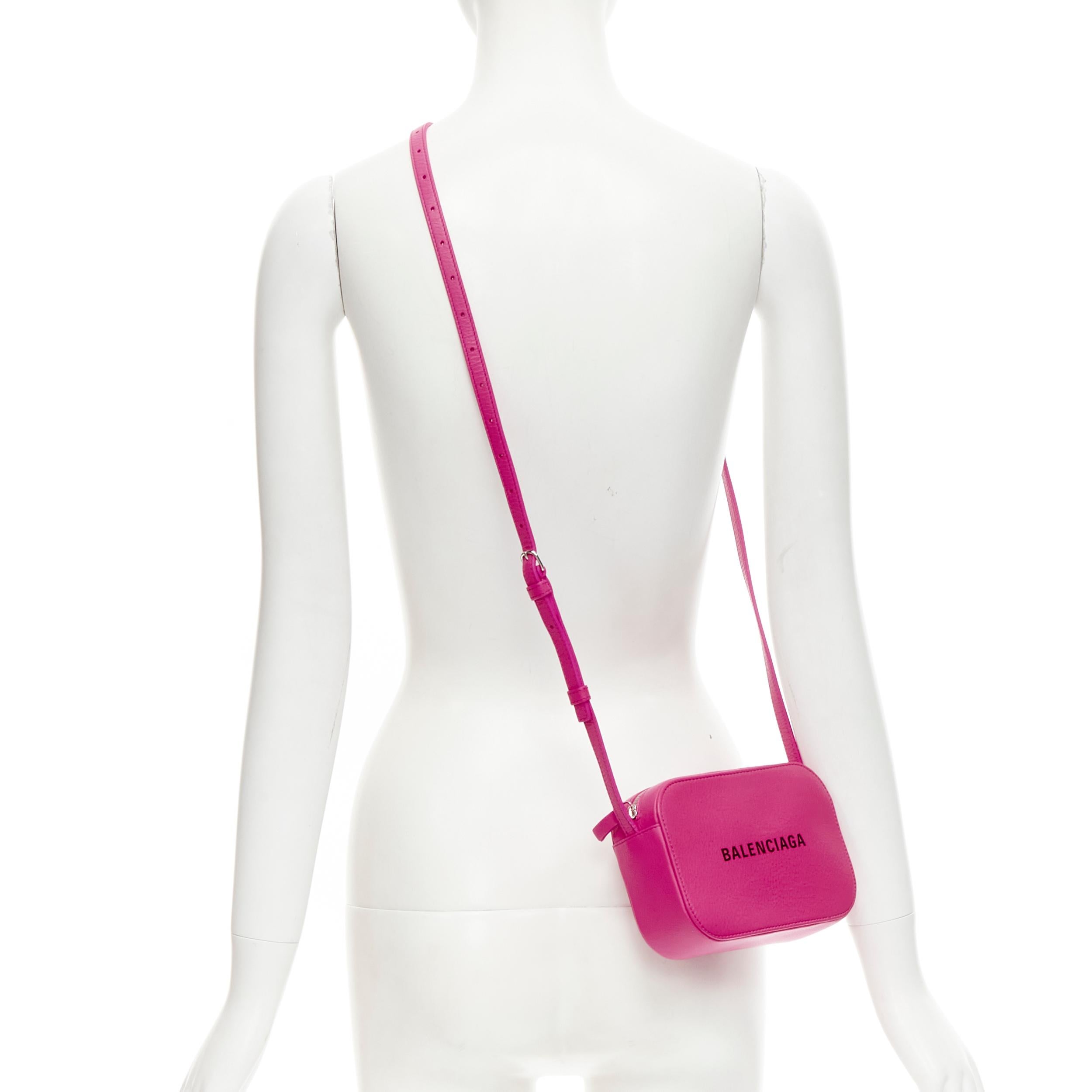 BALENCIAGA XS Everyday fuschia pink logo print crossbody camera bag 
Reference: SNKO/A00172 
Brand: Balenciaga 
Designer: Demna 
Model: XS Everyday Camera 
Material: Leather 
Color: Pink 
Pattern: Solid 
Closure: Zip 
Extra Detail: Adjustable