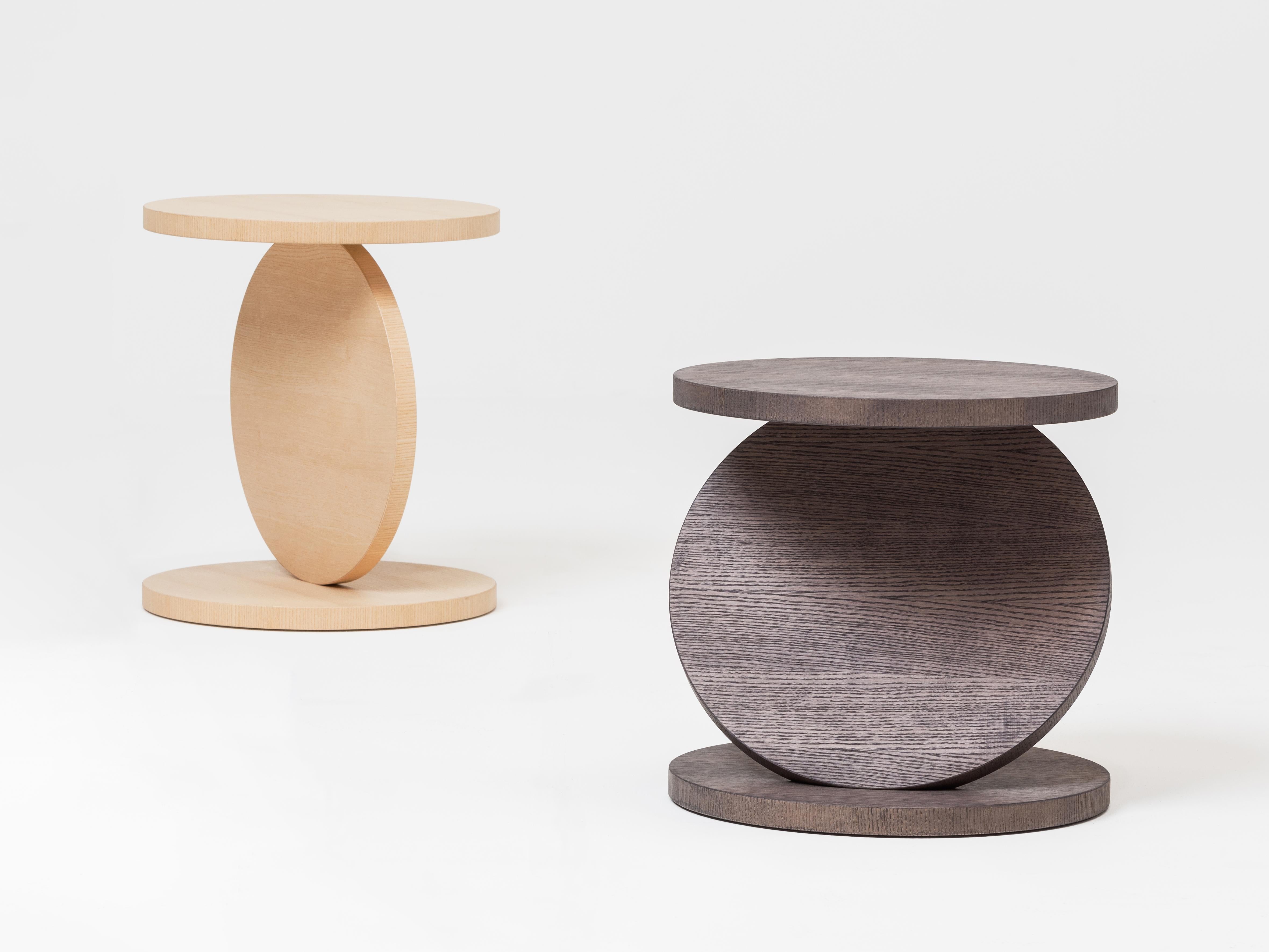 The geometrically shaped yet dynamic solid wood coffee tables in the Match Point collection come in three different heights and boast natural wooden finishes. Three circular discs – held together and balancing at 30, 60 and 90 degrees – are at the