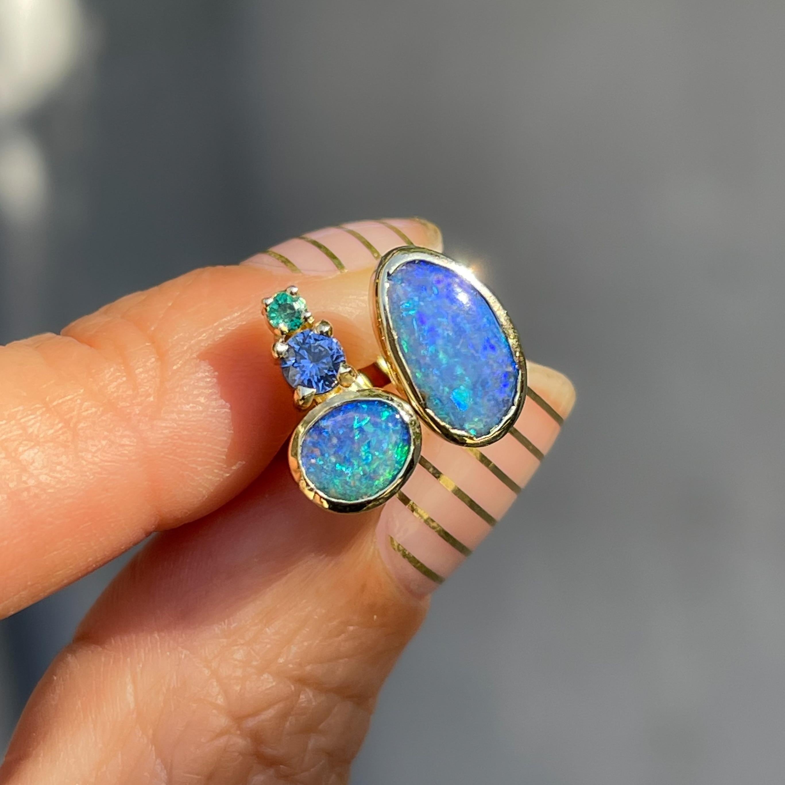 Australian Opal meets emerald and blue sapphire in the Bali Emerald and Opal Stud Earrings.  Each Boulder Opal in this pair of mismatched earrings reflects gorgeous blues and greens drawn right from the sea.  These stunning hues are echoed in the