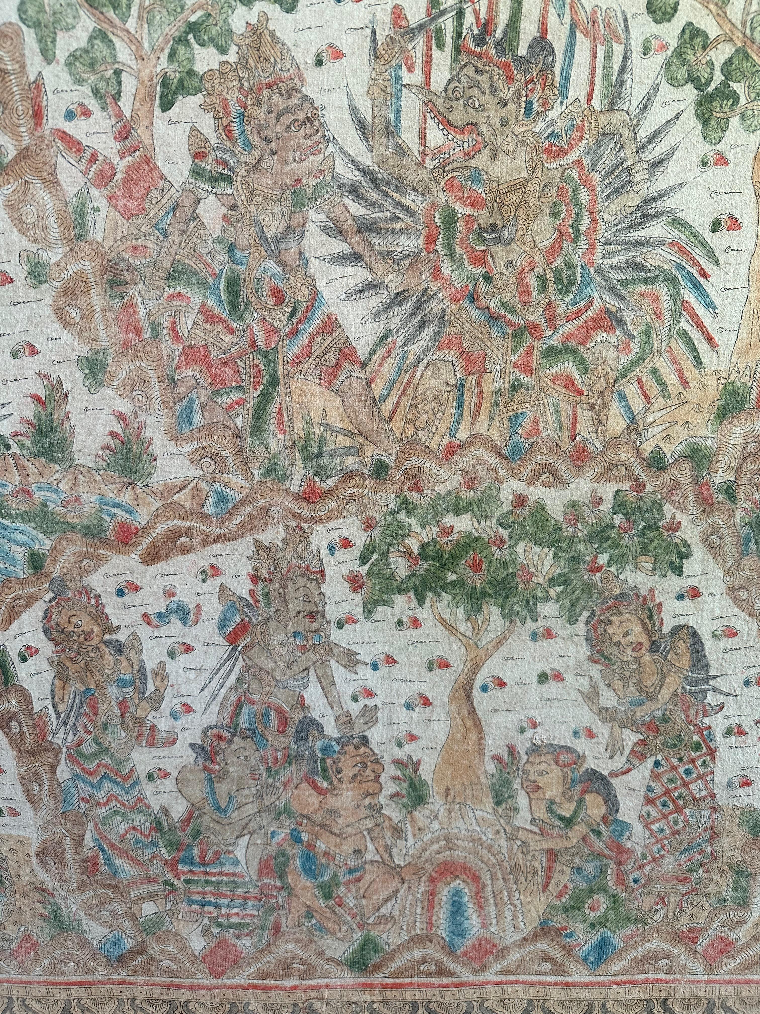 A Mid-20th Century 'Kamasan' cotton textile painting from Bali, Indonesia. The hand painted image has great detail and depicts Balinese Hindu mythology. This textile painting is stretched over a canvas, bordered by a teak wood frame and is ready to