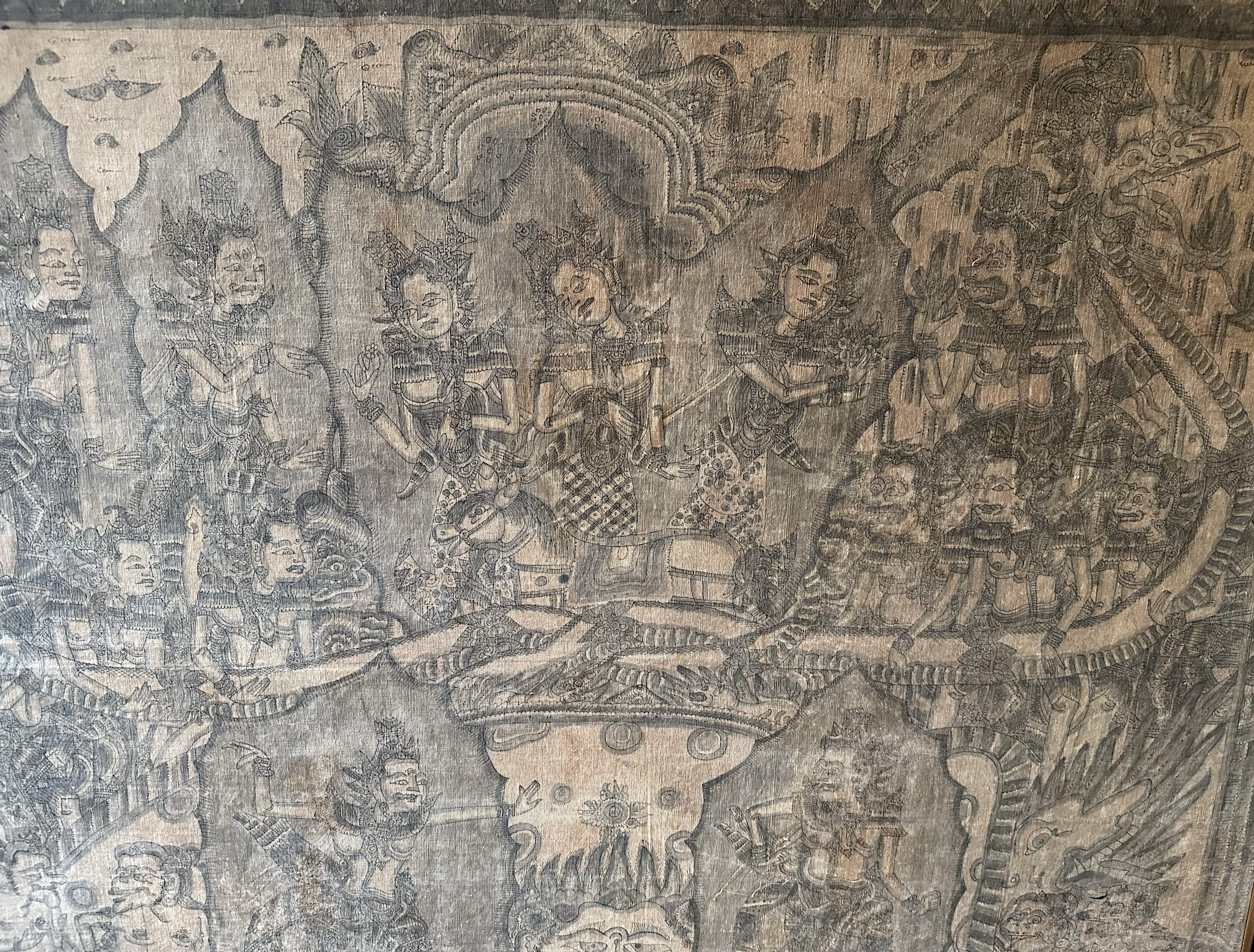 A mid-20th century 'Kamasan' cotton textile painting from Bali, Indonesia. The hand-painted image has great detail and depicts Balinese Hindu mythology. Key features of this image are the large 