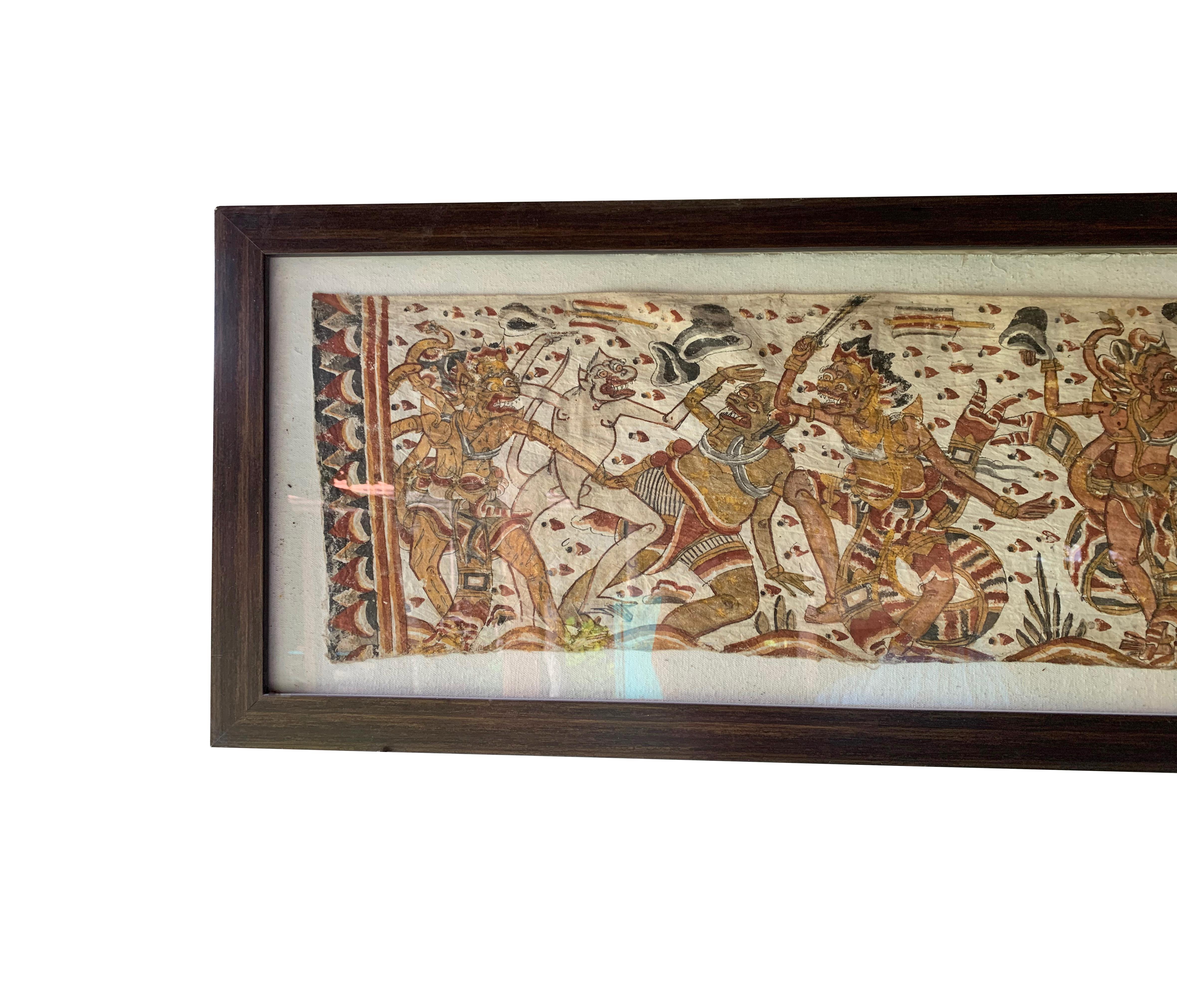 An early 20th century 'Kamasan' cotton textile painting from Bali, Indonesia. The hand-painted image has great detail and depicts Balinese Hindu mythology. It has been framed with a glass front and is ready to be wall mounted with a wall hanging