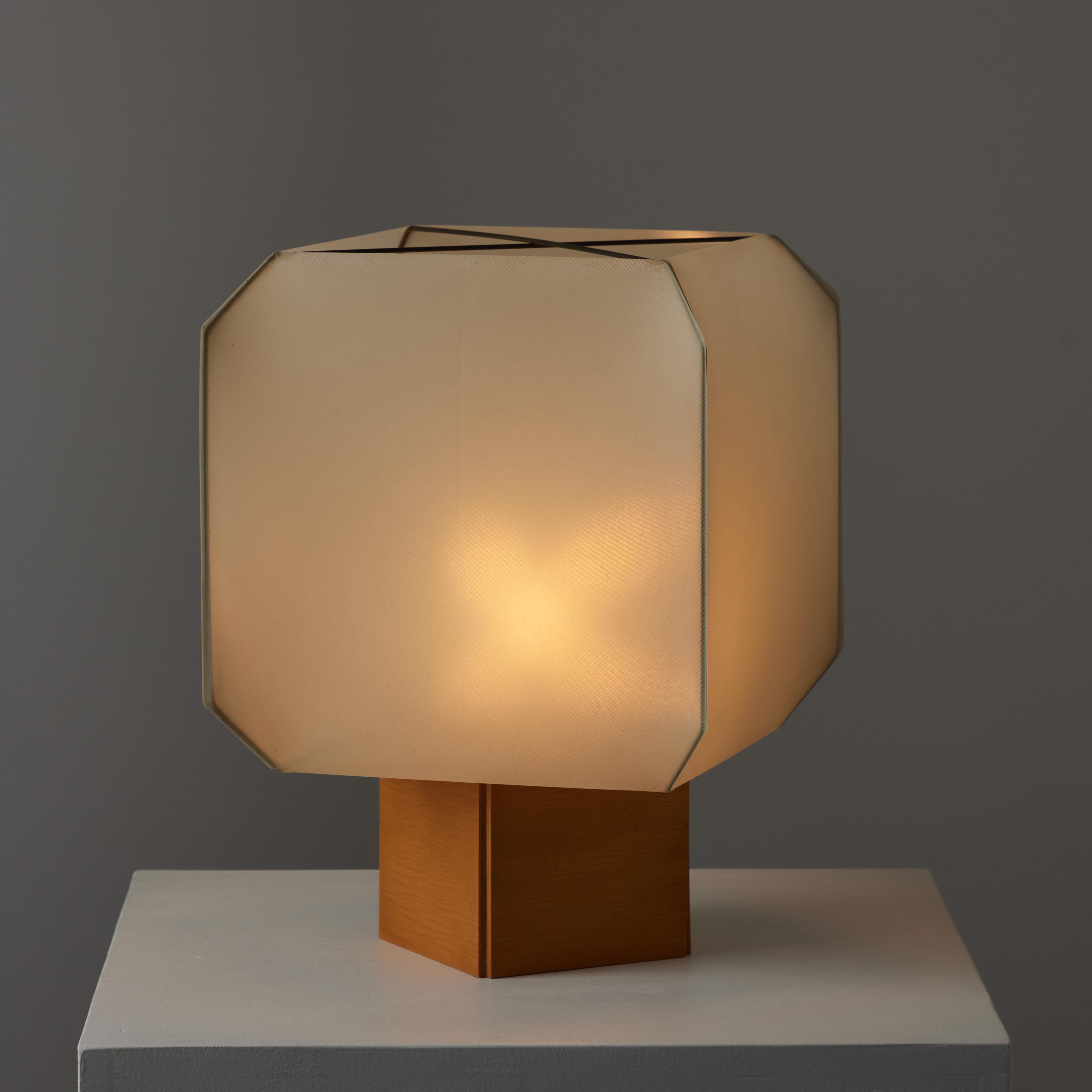Bali table lamp by Bruno Munari for Danese. Designed and manufactured in Italy, 1958. Resin fabric shade and wooden base. Original cord with on/off switch. Holds a single E27 socket, adapted for the US. We recommend one 40w maximum bulb. Bulb