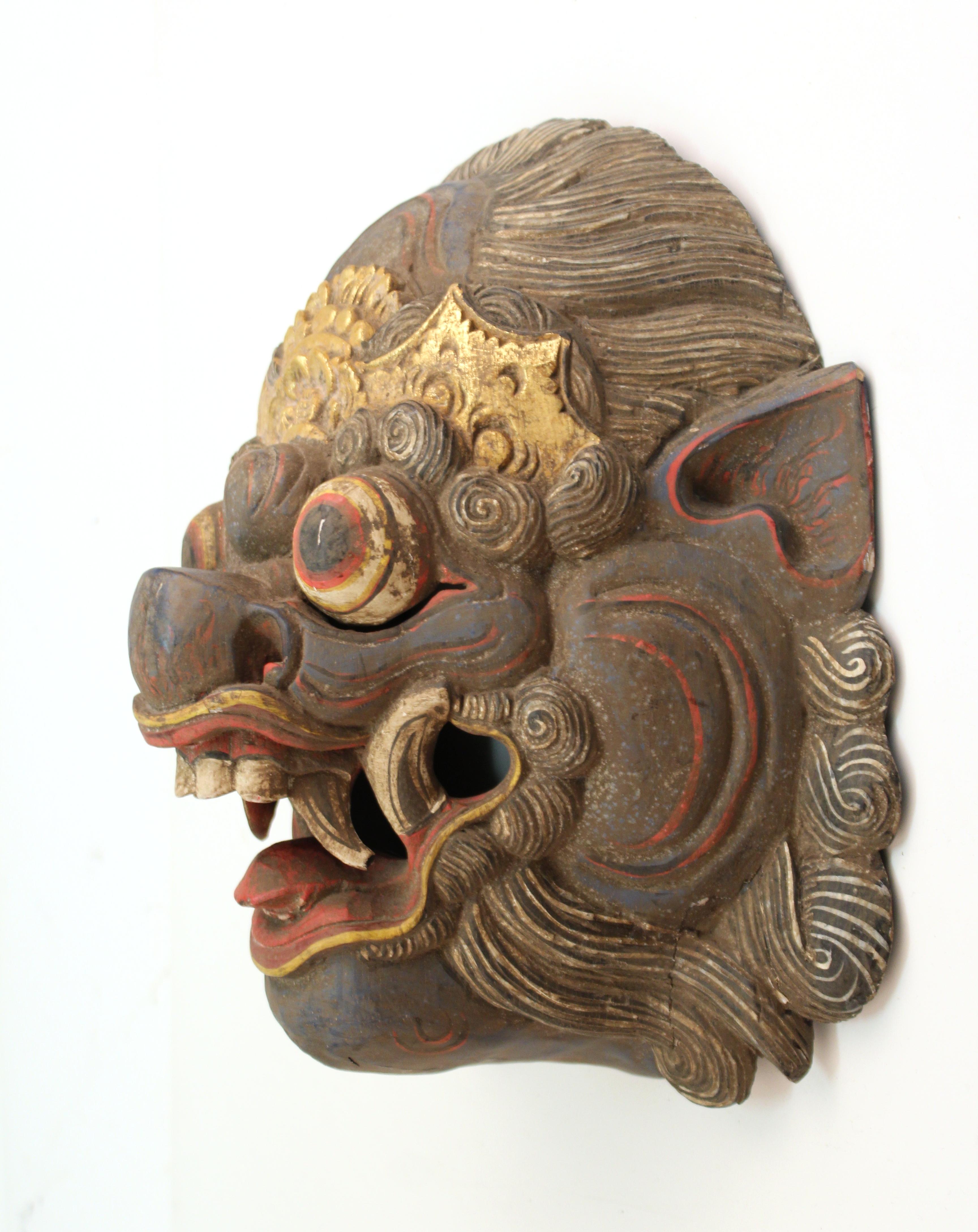 Balinese Barong hand carved and hand painted wood dance mask of an ornate colorful mythological creature. The piece is in good vintage condition and was produced during the 20th century. Some age-appropriate wear.