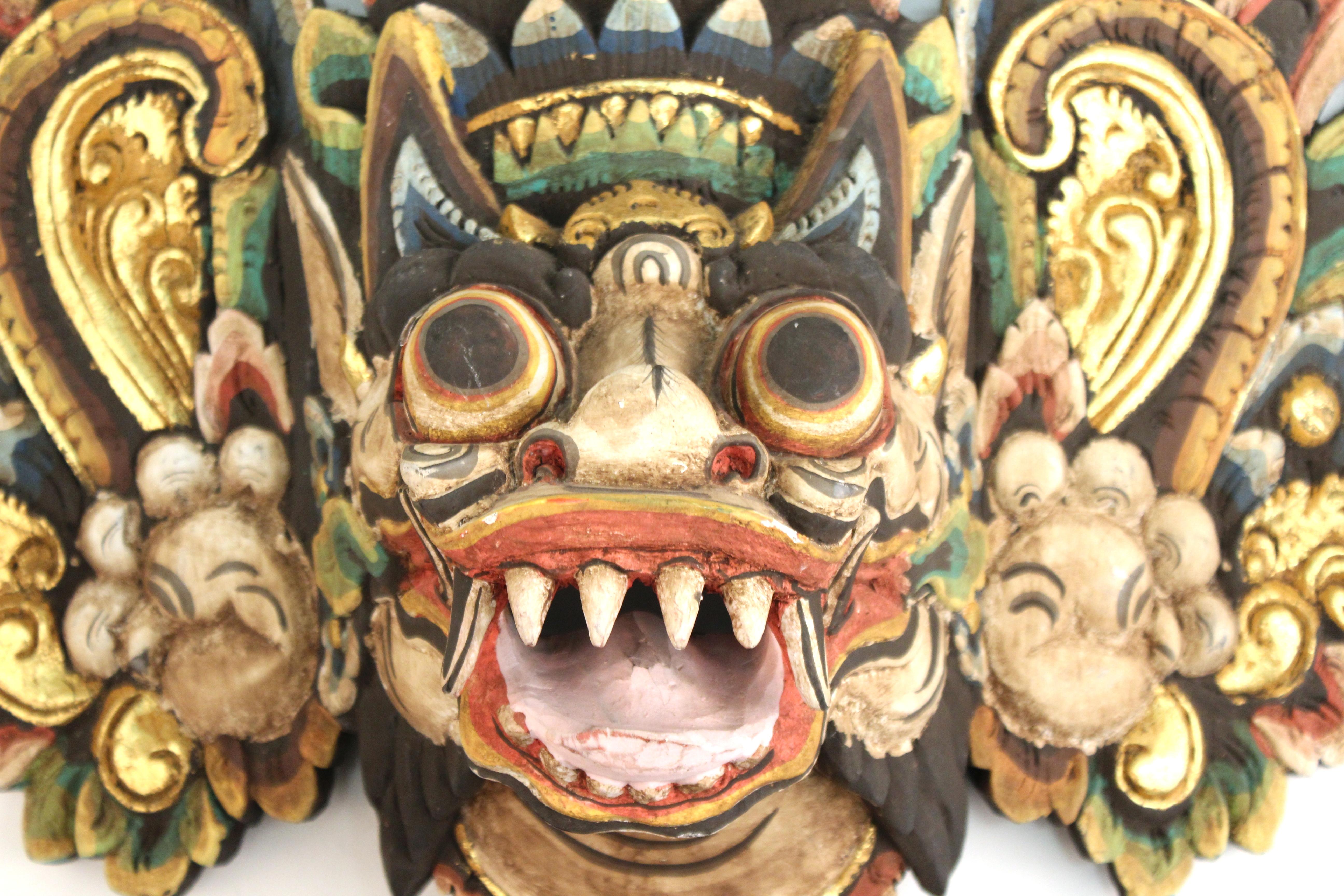 Balinese Barong carved and hand painted wood dance mask of an ornate colorful mythological creature. The piece is in good vintage condition and was produced during the 20th century. Some age-appropriate wear.
