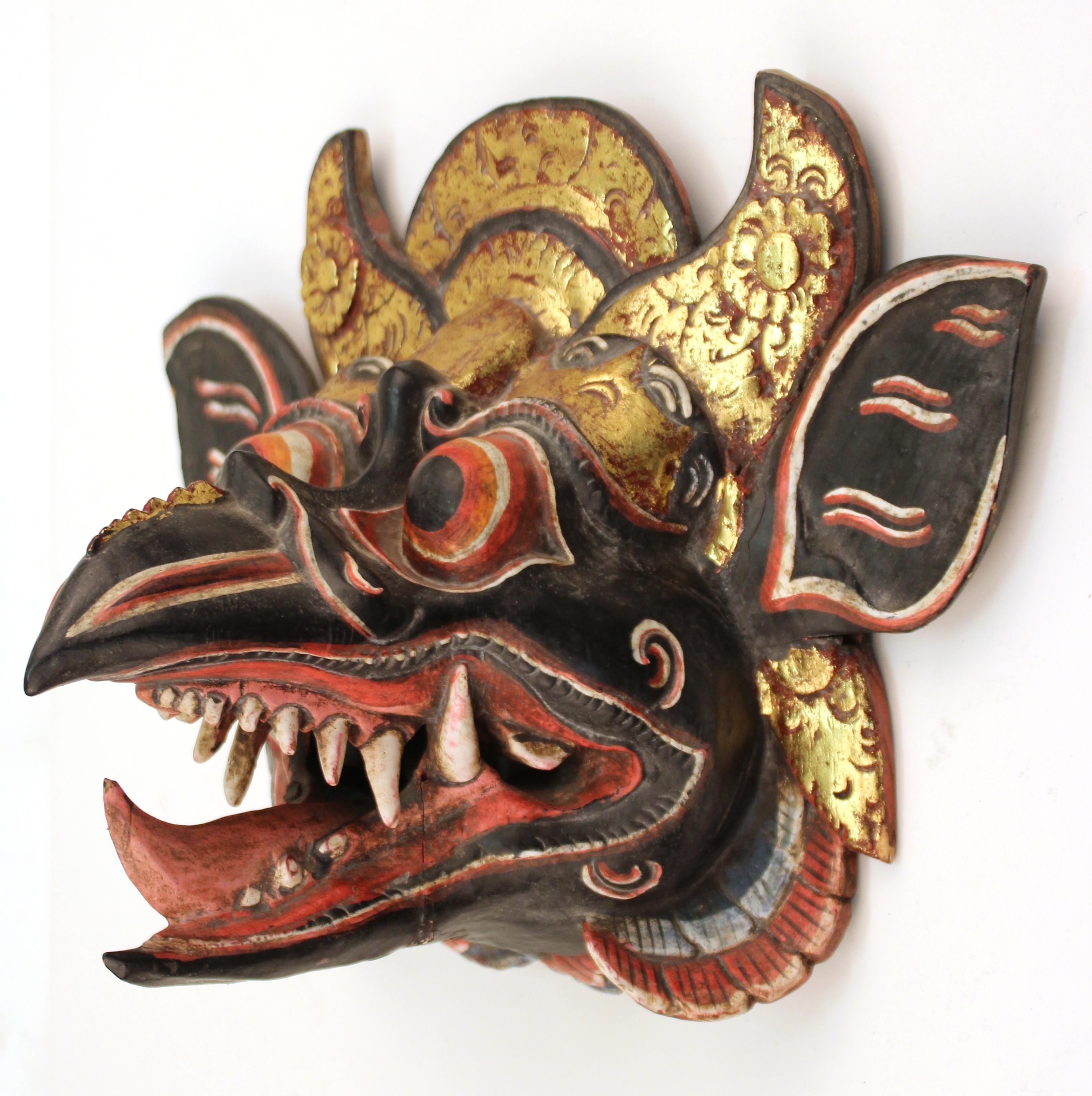 Balinese Barong dance mask of Garuda, the vehicle of Vishnu ornately hand carved and colorfully hand painted wood mask. The piece is in good vintage condition and was produced during the 20th century. Some age-appropriate wear.