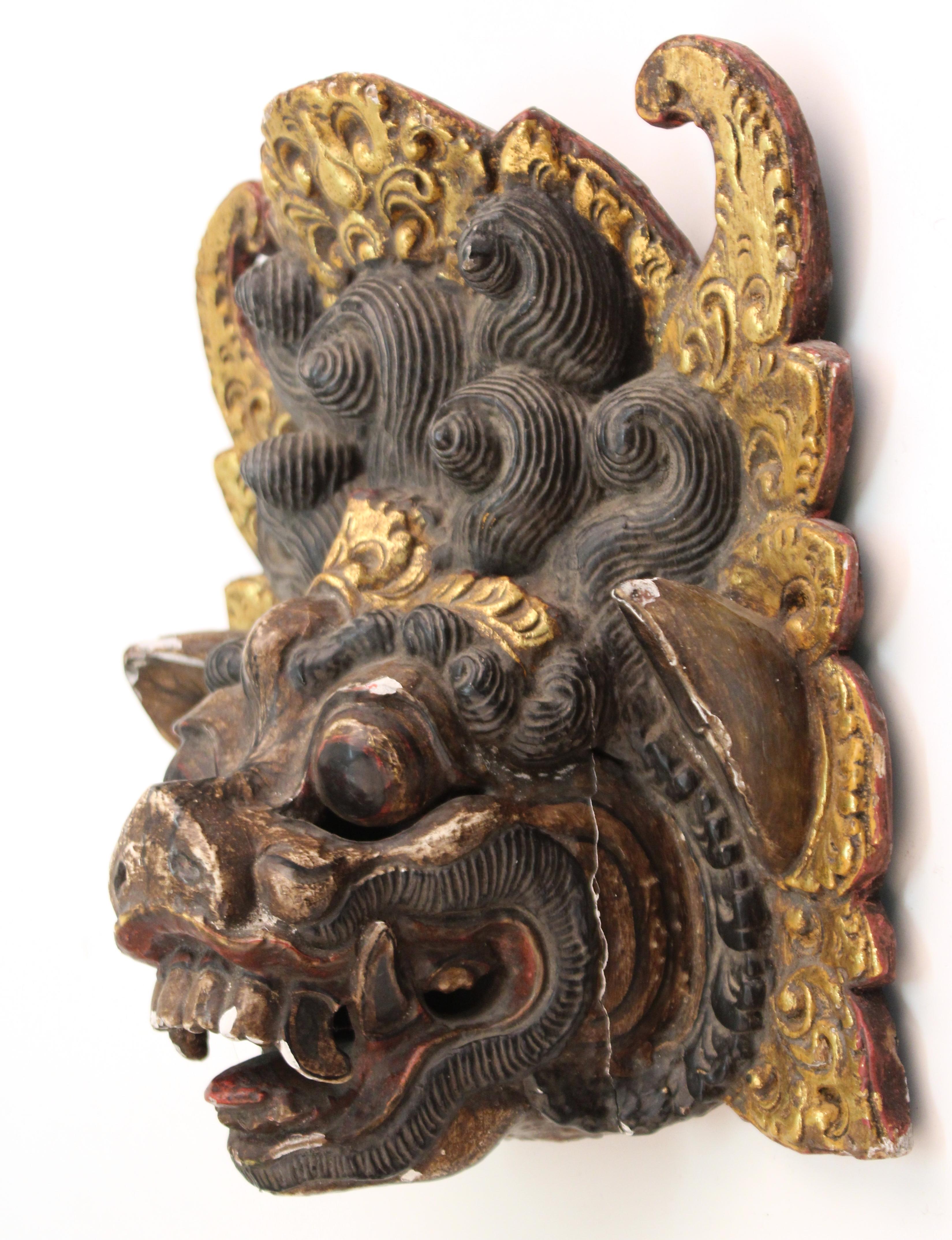 Hand carved and hand painted wood Balinese Barong dance mask of an ornate colorful mythological creature. The piece is in good vintage condition and was produced during the 20th century. Some age-appropriate wear.