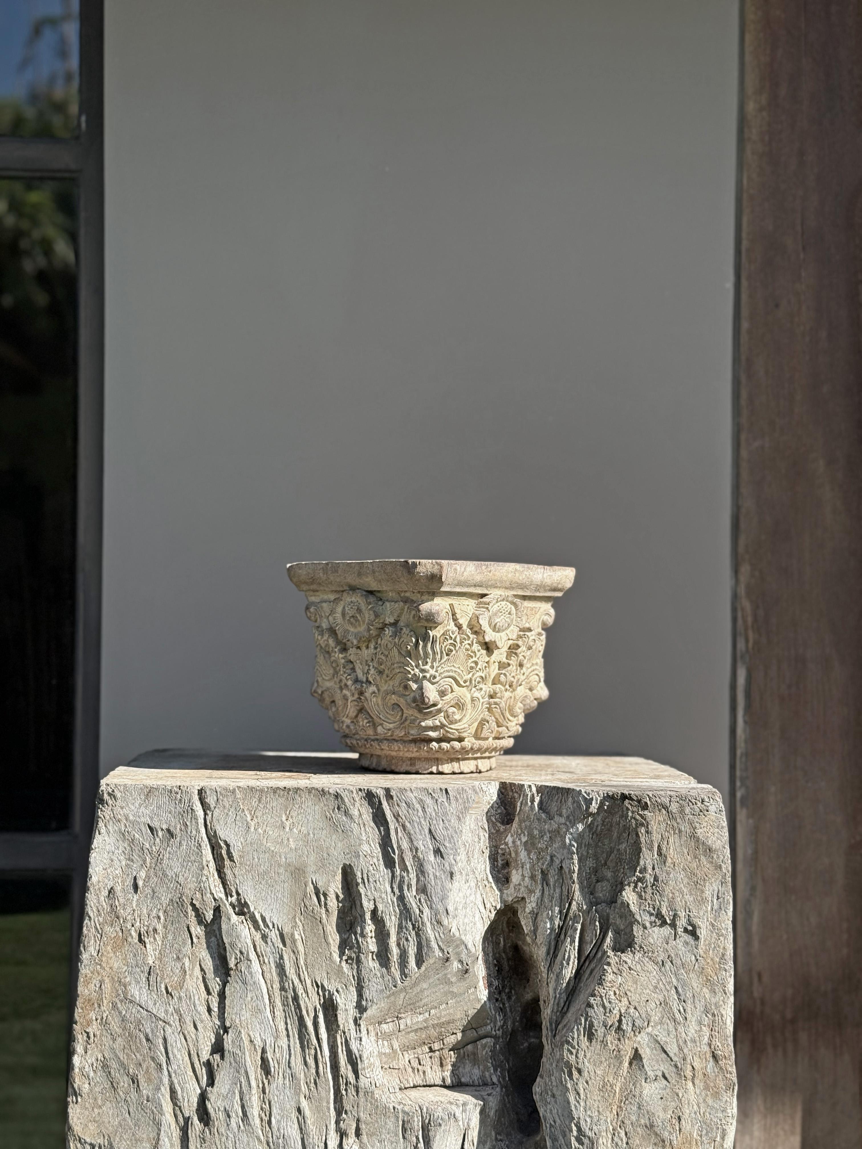 This exquisite hand-carved wooden column chapiter showcases a masterful blend of cultural symbolism and botanical artistry. Featuring a central Barong motif, the piece draws inspiration from Balinese mythology, where Barong represents protection and