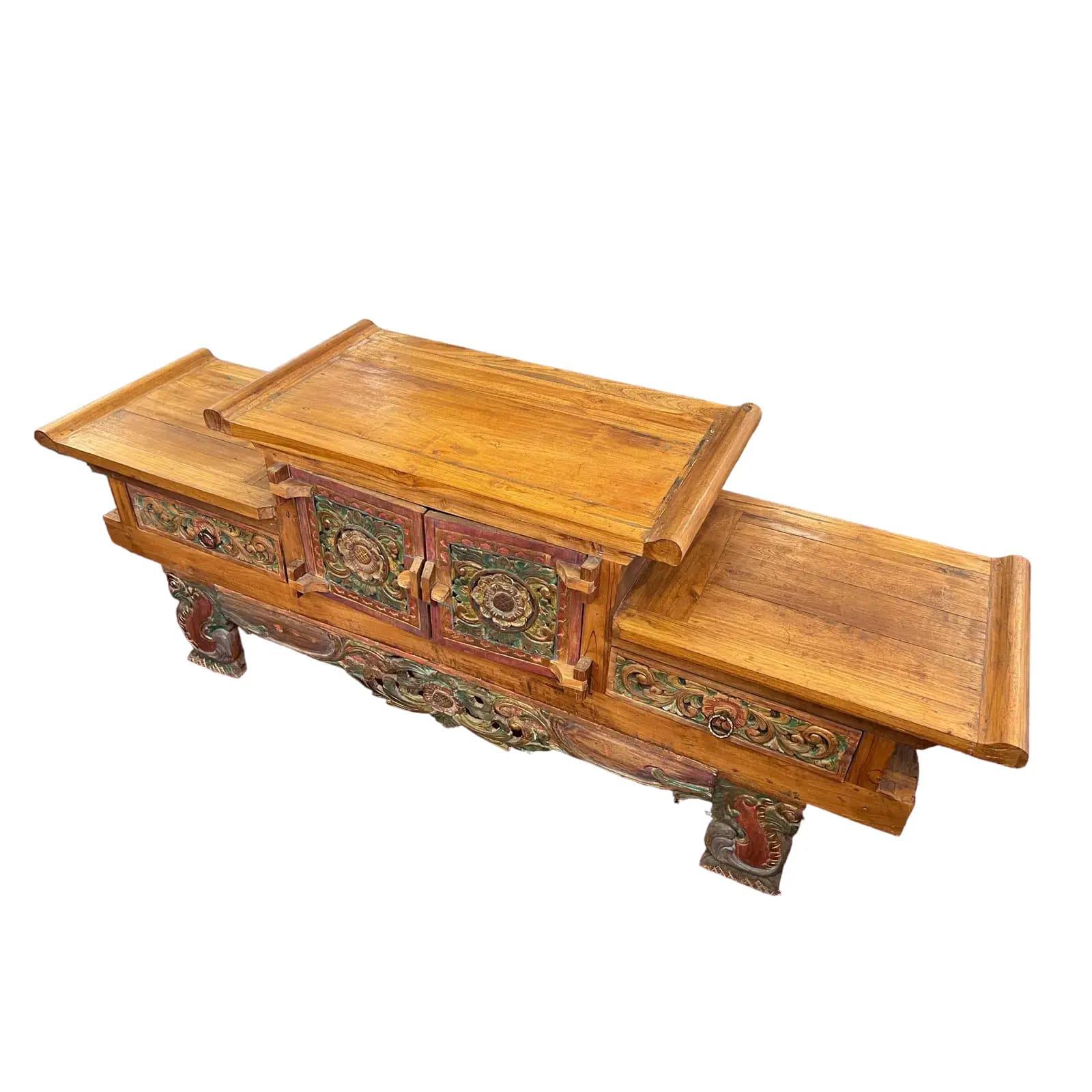 Balinese Hand-Carved Teak Wood Hi-Lo Cabinet, a magnificent piece crafted in the timeless antique altar style. This exquisite cabinet showcases the rich cultural heritage and skilled craftsmanship of Bali, Indonesia.

The cabinet is meticulously