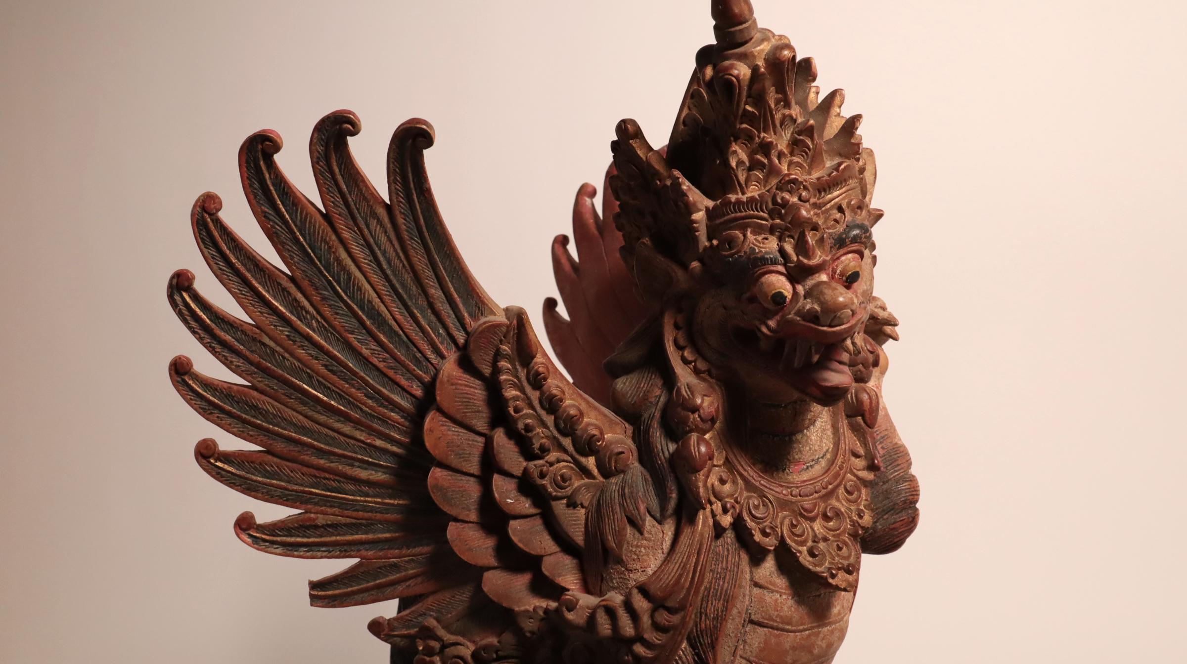 Last chance clearance sale.  A tour-de-force from a master Balinese sculptor, with amazing detail, carved in very hard, dense wood.
A winged lion (called a singha) temple or palace guardian. Bali, Indonesia. Expertly carved wood with paints, 20th