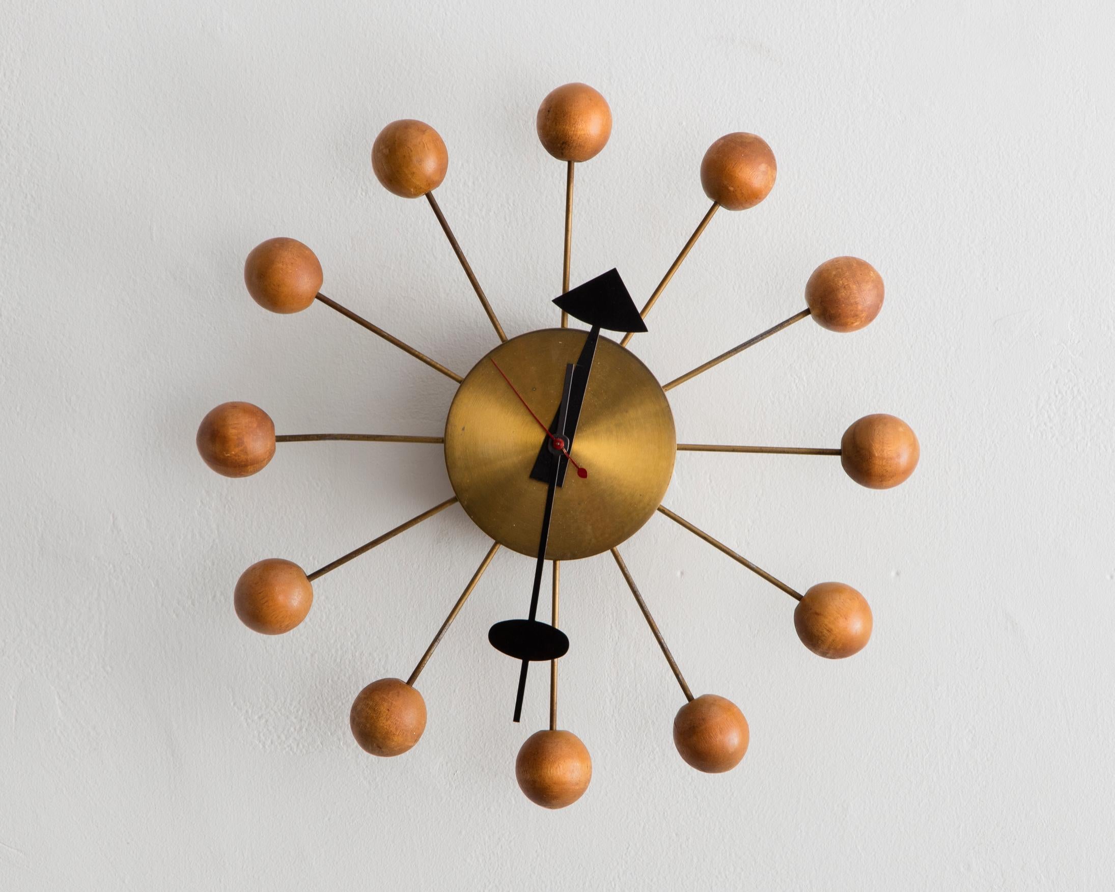 Ball wall clock, model no. 4755. Designed 1947, this example produced 1948-50. Manufactured by Howard Miller Clock Company, Zeeland, MI. Brass, steel, maple. The ball clock was included in An Exhibition for Modern Living at the Detroit Institute of