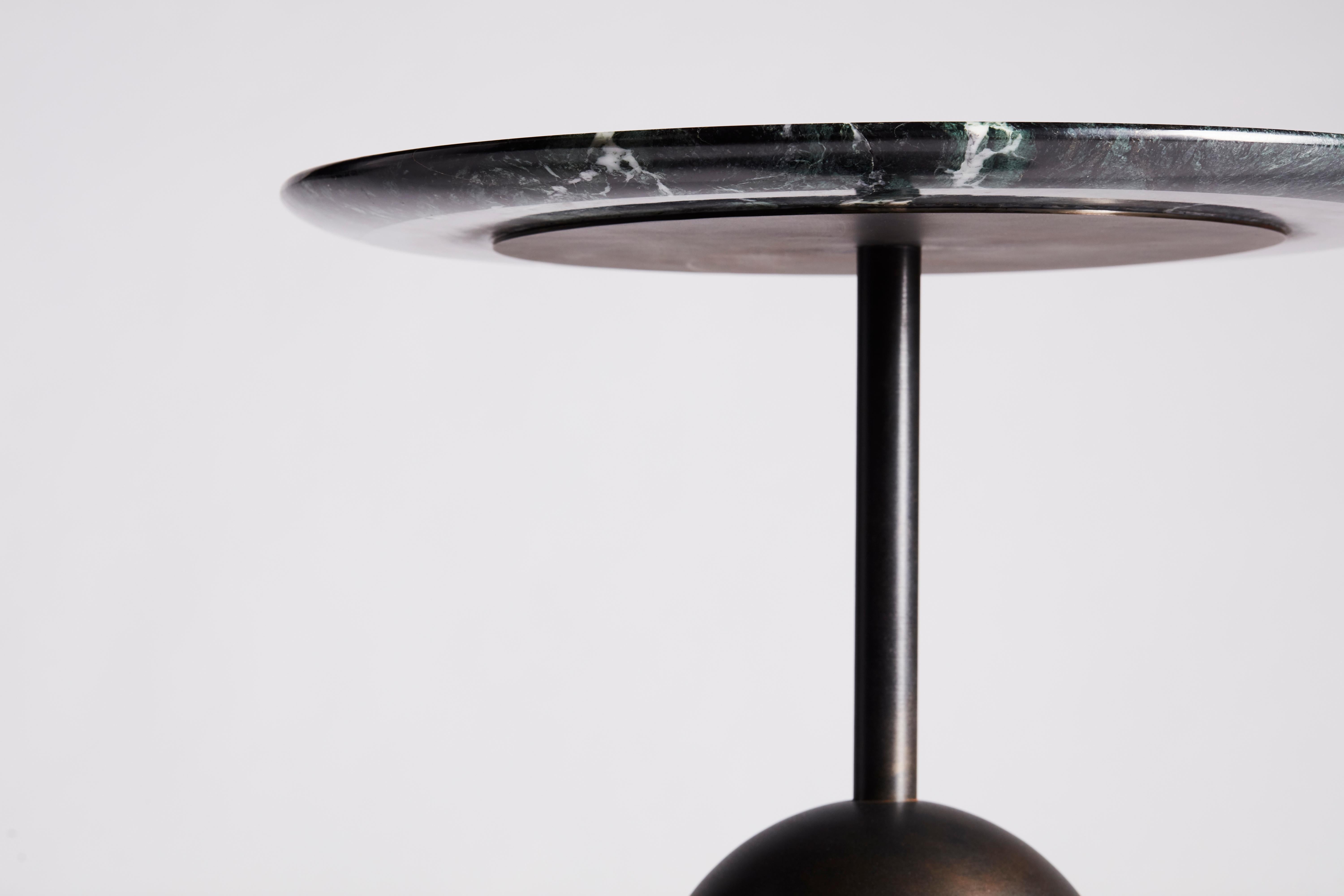Reflecting the notion of balance, the Ballast Table exhibits a dynamic character of proportion and contrast of materials. The table features a weighted cylindrical base with a hand finished black patina and chamfered marble top.