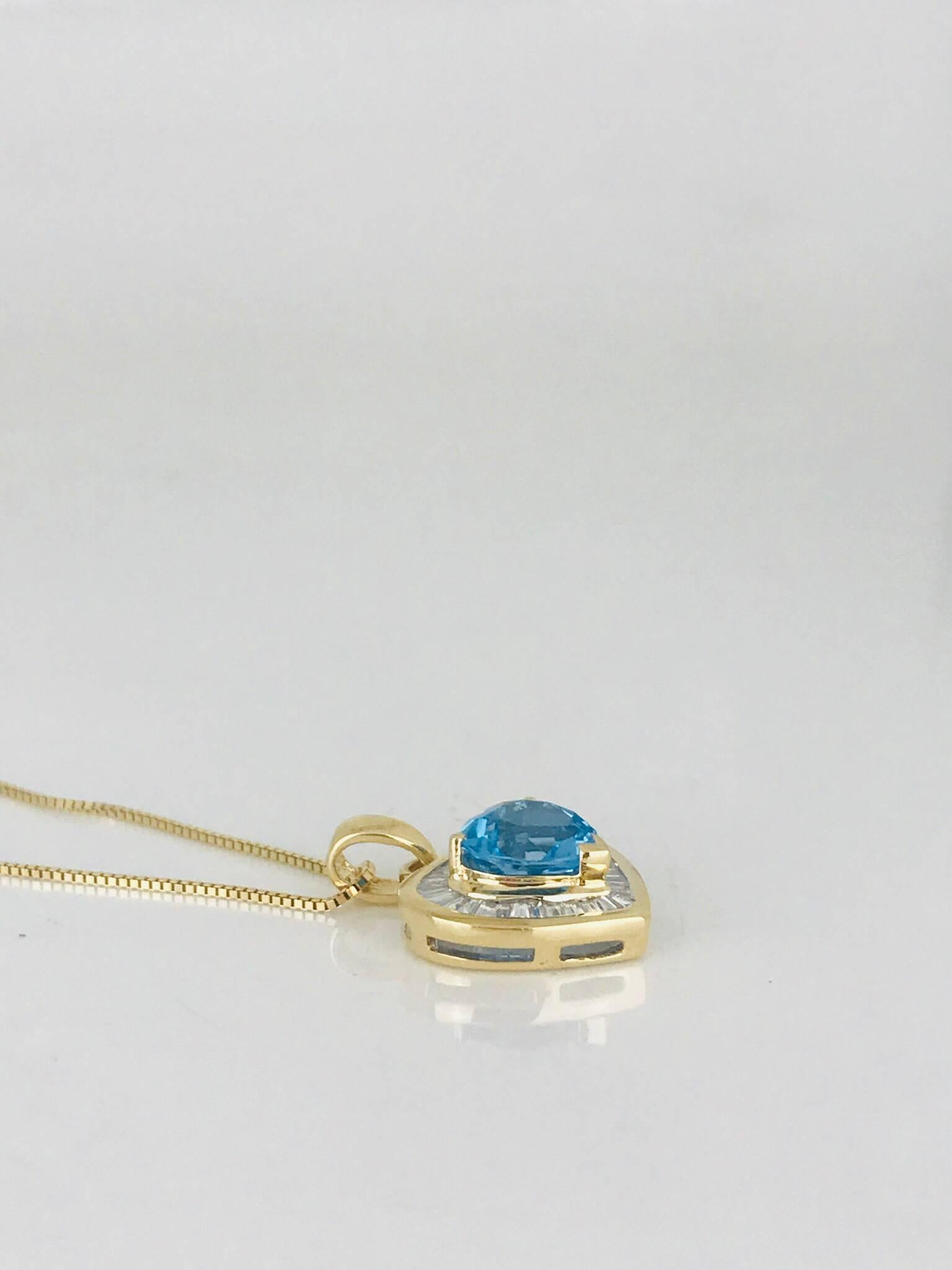 14 Karat yellow gold, Ballerina Baguette Diamond Heart. The diamonds are set surrounding a heart shaped, Swiss colored blue topaz. 
The (40) diamonds are channel set and measure approximately 1.85 mm x .80 mm in diameter.  
The total diamond weight