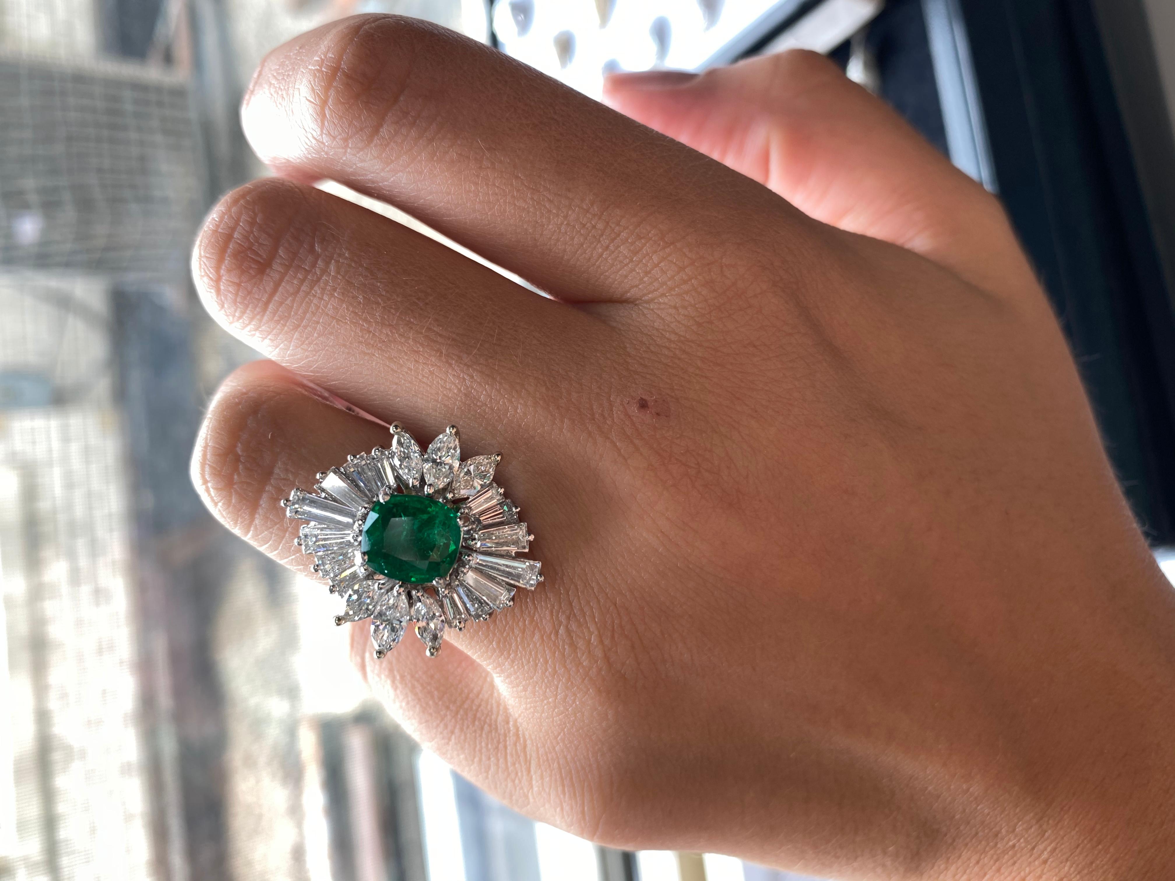 Platinum Green Emerald Diamond ring in Ballerina Diamond mounting, features 2.82 Carats Green Emerald cushion cut, set with 6.50 Carats of diamonds. marquise and baguette diamonds. 
The side diamonds are F color VS in clarity. 