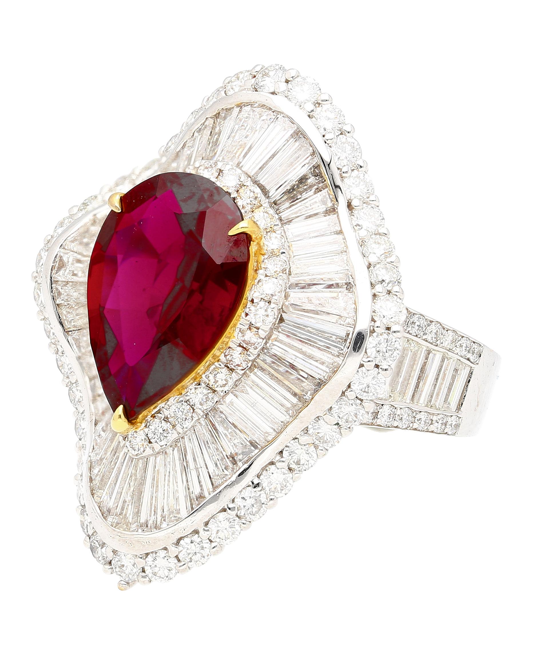 This ballerina ring features a 5.30 carat pear ruby from Thailand (Siam) adorned by 55 trillion and baguette cut diamonds, totaling 5.14 carats and 98 round cut diamonds, totaling 1.69 carats. The ruby is prong set in 18k yellow gold, and the