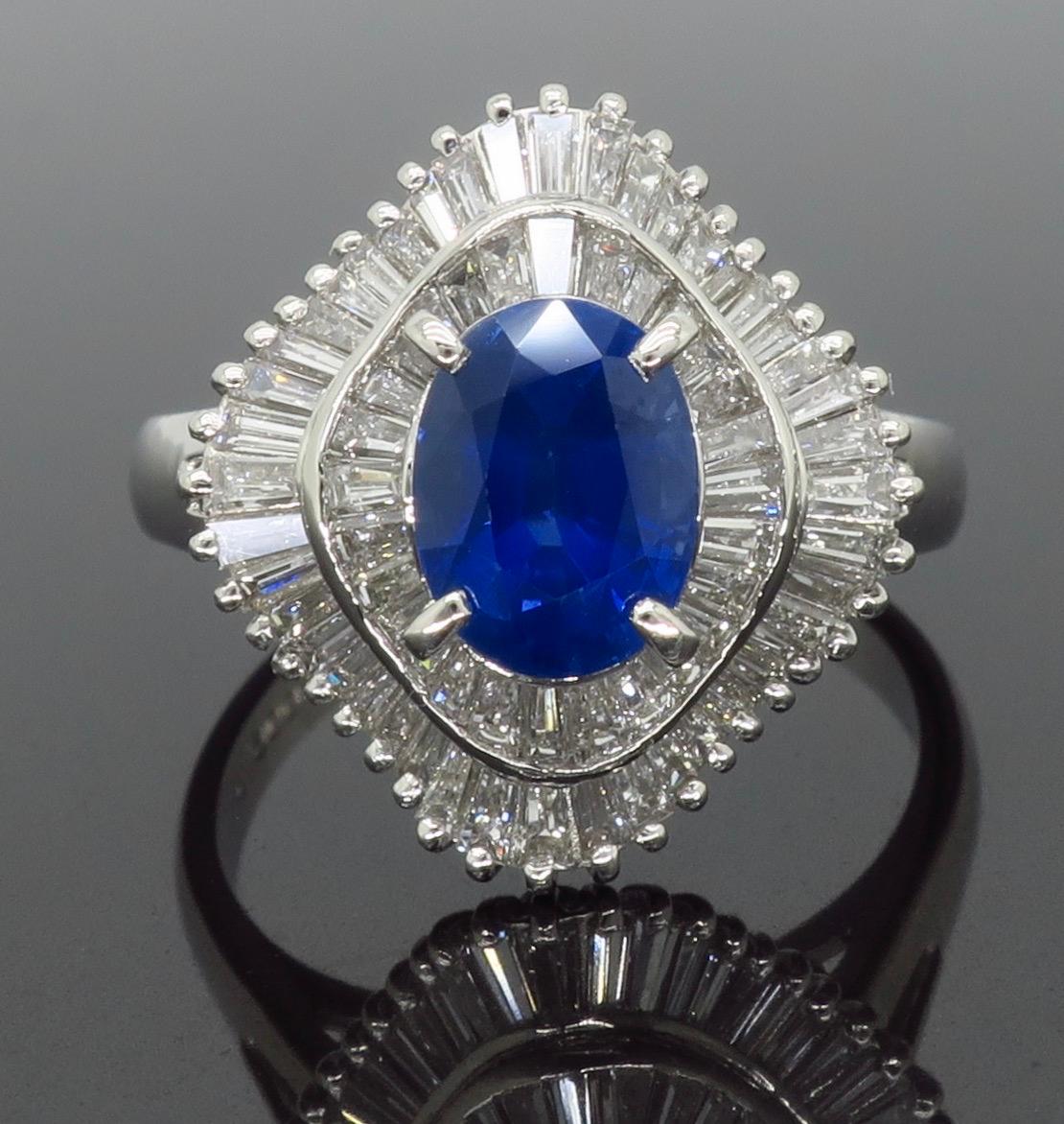Ballerina style blue sapphire and diamond ring crafted in platinum.

Gemstone: Sapphire & Diamonds
Gemstone Carat Weight:  Approximately 1.318CT
Diamond Carat Weight:  Approximately .93CTW
Diamond Cut: Tapered Baguette Cut
Color: Average