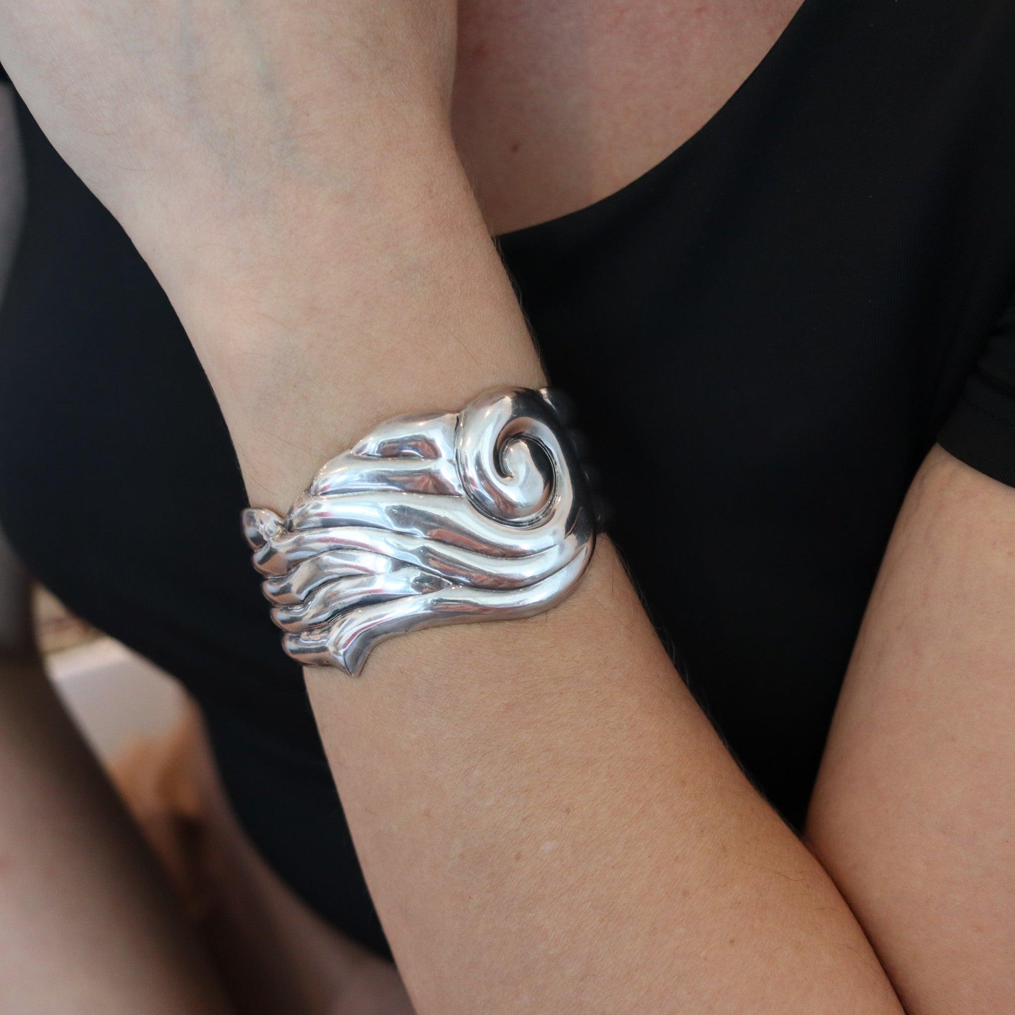 Cuff bracelet designed by Taller De Los Ballesteros.

Beautiful vintage cuff bracelet, created in the city of Taxco Mexico by the Taller De Los Ballesteros, back in the 1970. The unusual cuff was crafted  in high relief with modernist patterns in