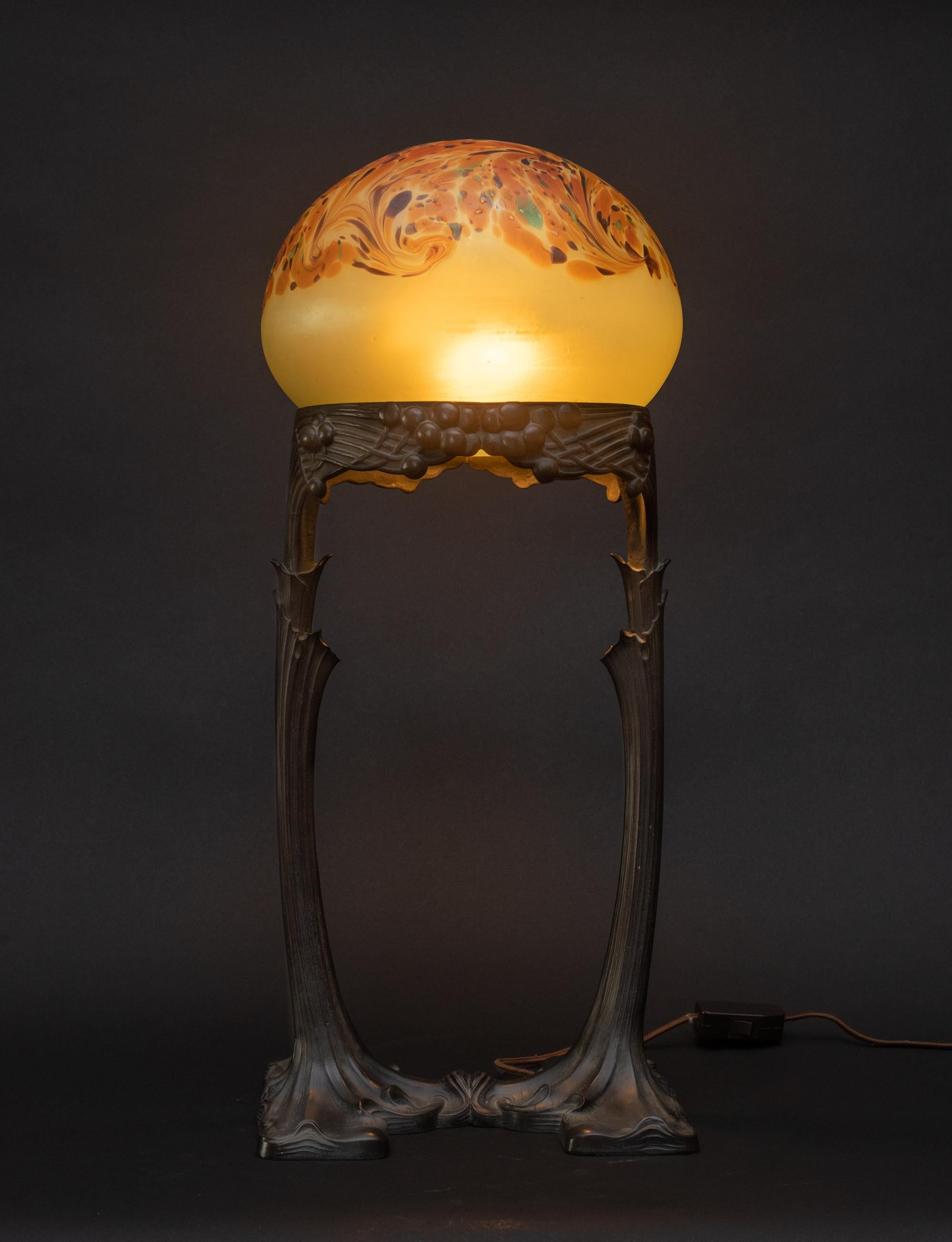 Art Nouveau BALLOON GLASS TABLE LAMP, by Gustav Gurschner and Johann Loetz Witwe, c. 1904, the glass dome in a frosted yellow iridescent ground is crowned by orange abstract swirls accented by dabs of aubergine and green; it rests on a chocolate