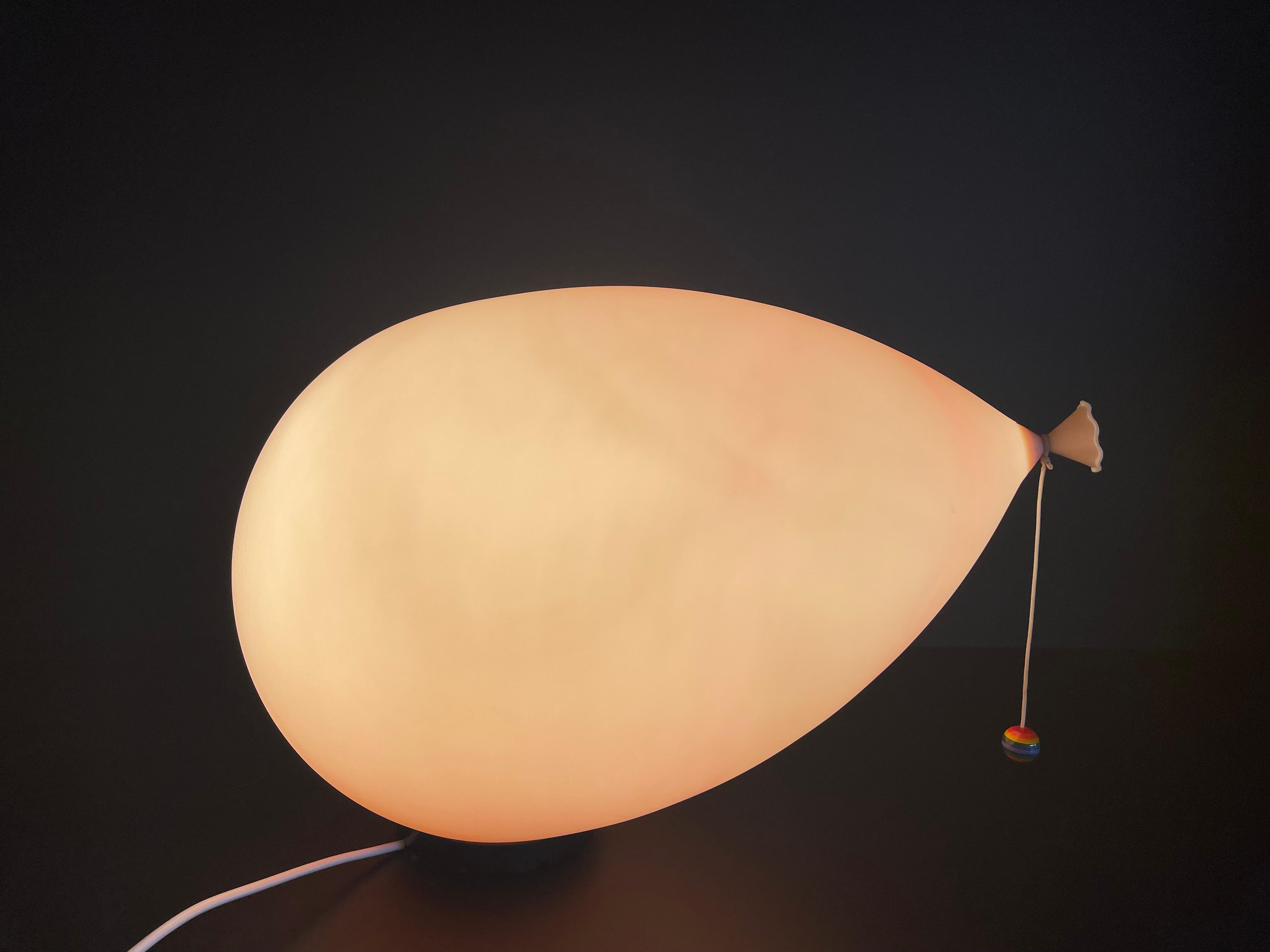 A very nice pink balloon lamp by Yves Christin for Bilumen. This lamp can be used as a table lamp or wall lamp. The condition of this lamp is very good.