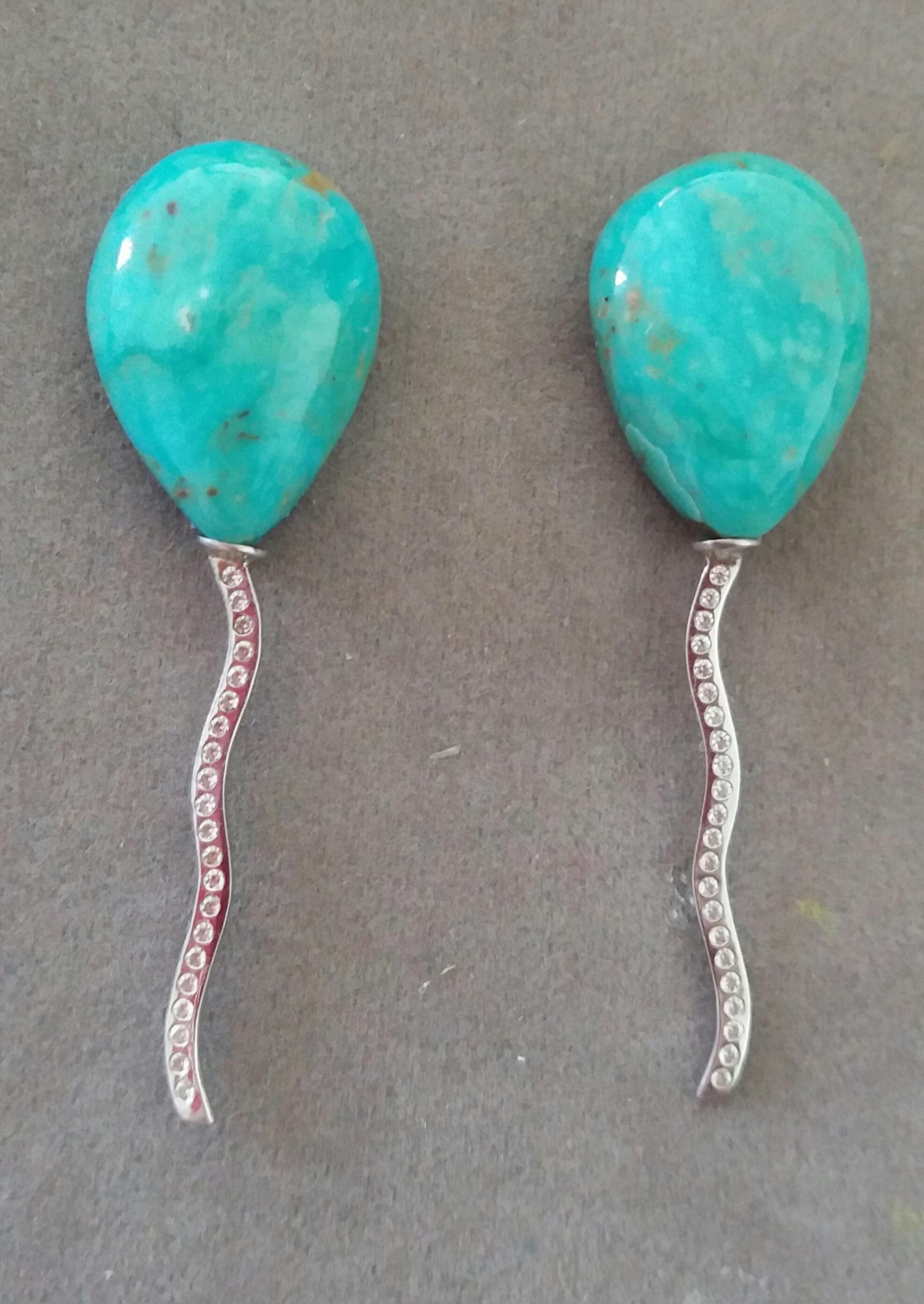 2 pear-shaped Natural Turquoise pear shape cabs measuring 15 x 21 mm. mounted like balloons with the thread holding them made of 14 carat White Gold and 44 small diamonds.

In 1978 our workshop started in Italy to make simple-chic Art Deco style