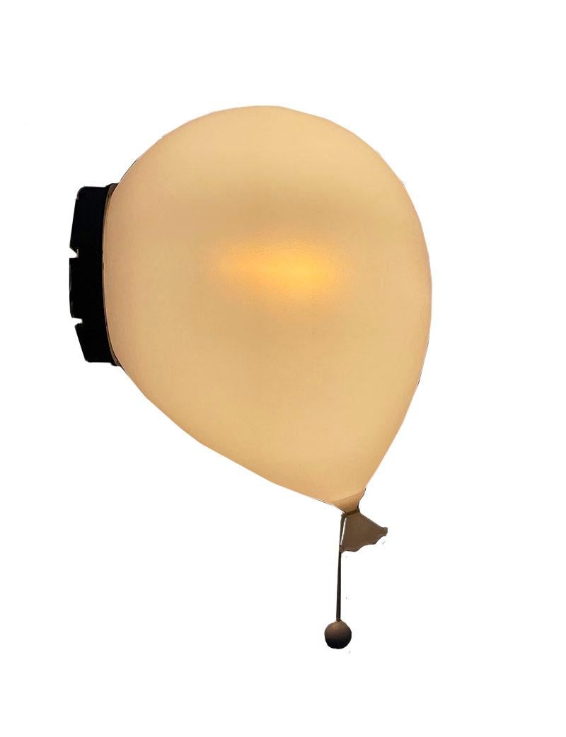 Balloon wall lamp by Yves Christin for Bilumen, Italy 1980s.

This iconic lamp was designed in 1984 by Yves Christin and manufactured by Bilumen, Italy. White plastic lampshade in the shape of a balloon on a black round mounting for the wall.