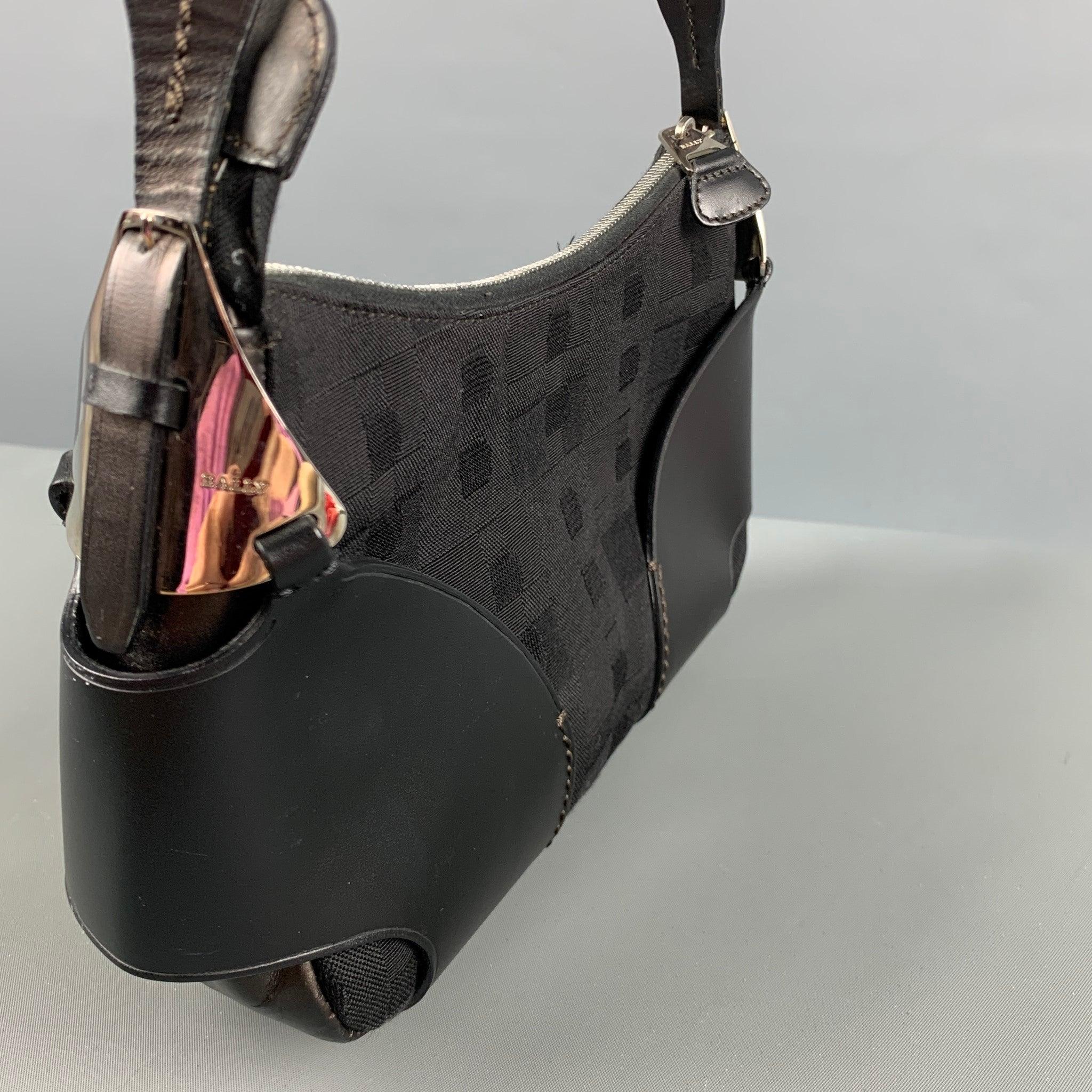 BALLY Vintage bag comes in a black monogram nylon material featuring black leather accents, inner pocket, and a zipper closure. Made in Italy.Very Good Pre-Owned Condition. Moderate signs of wear on the metal parts. 

Marked:   ACAG  

Measurements: