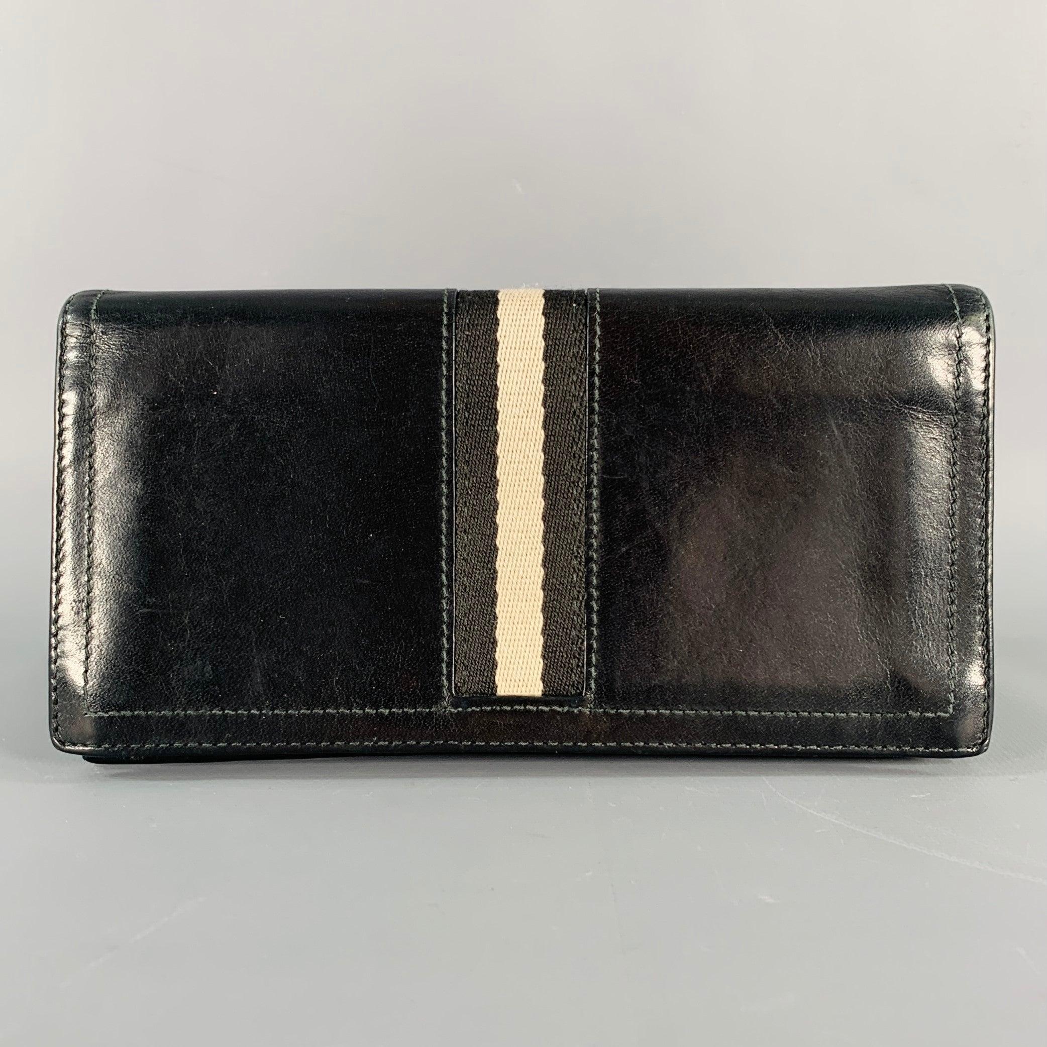 BALLY wallet in a black leather featuring a bifold style, black and grey stripe trim, and ten card slots.Very Good Pre-Owned Condition. Signs of wear inside of wallet.7 X 3.5 inches 
  
  
 
Sui Generis Reference: 134929
Category: Wallet
More