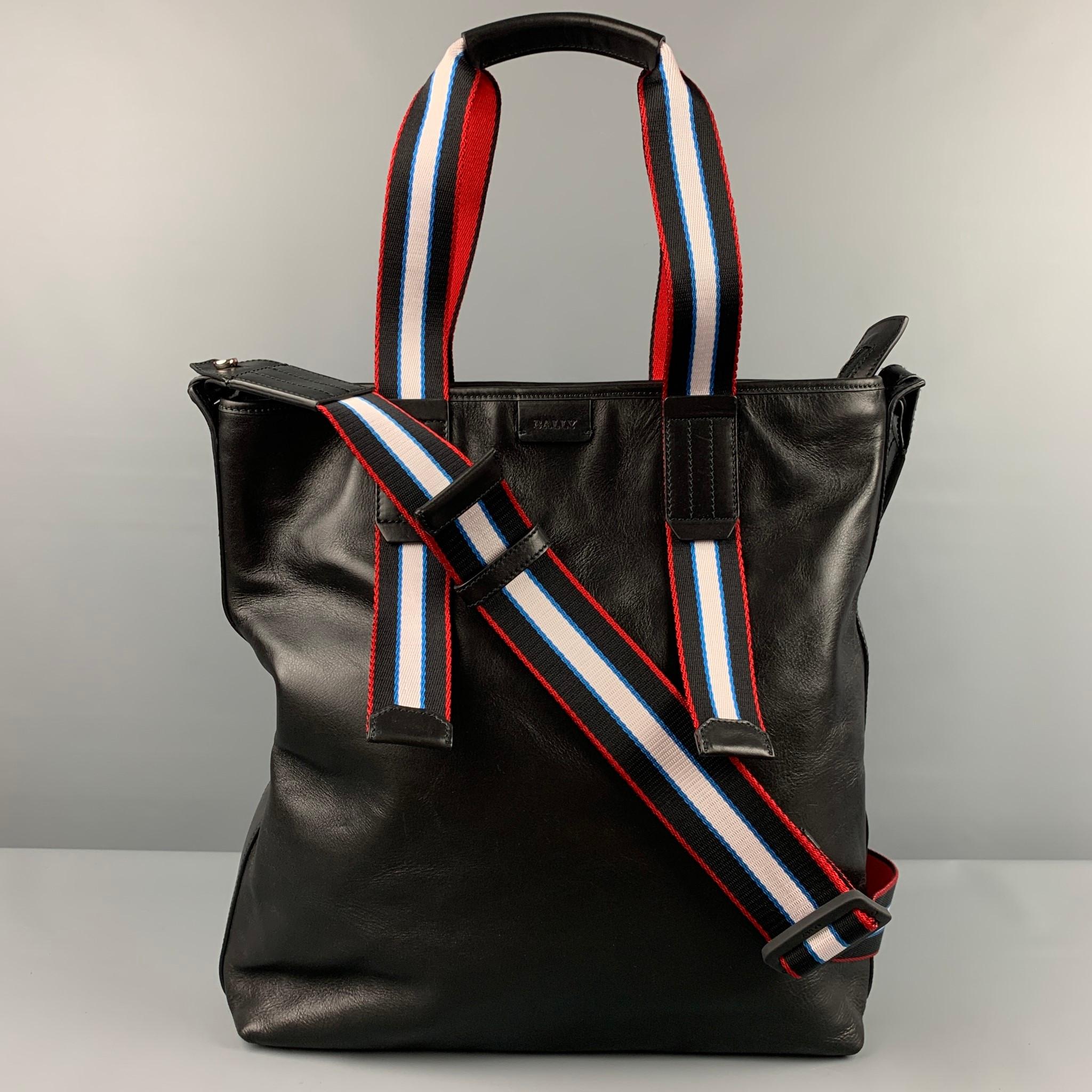BALLY bag comes in a black leather featuring a tote bag, top handles, detachable crossbody strap, inner pockets, and a zipper closure. Made in Italy.

Very Good Pre-Owned Condition.

Measurements:

Length: 13.5 in.
Width: 5 in.
Height: 15 in.
Drop:
