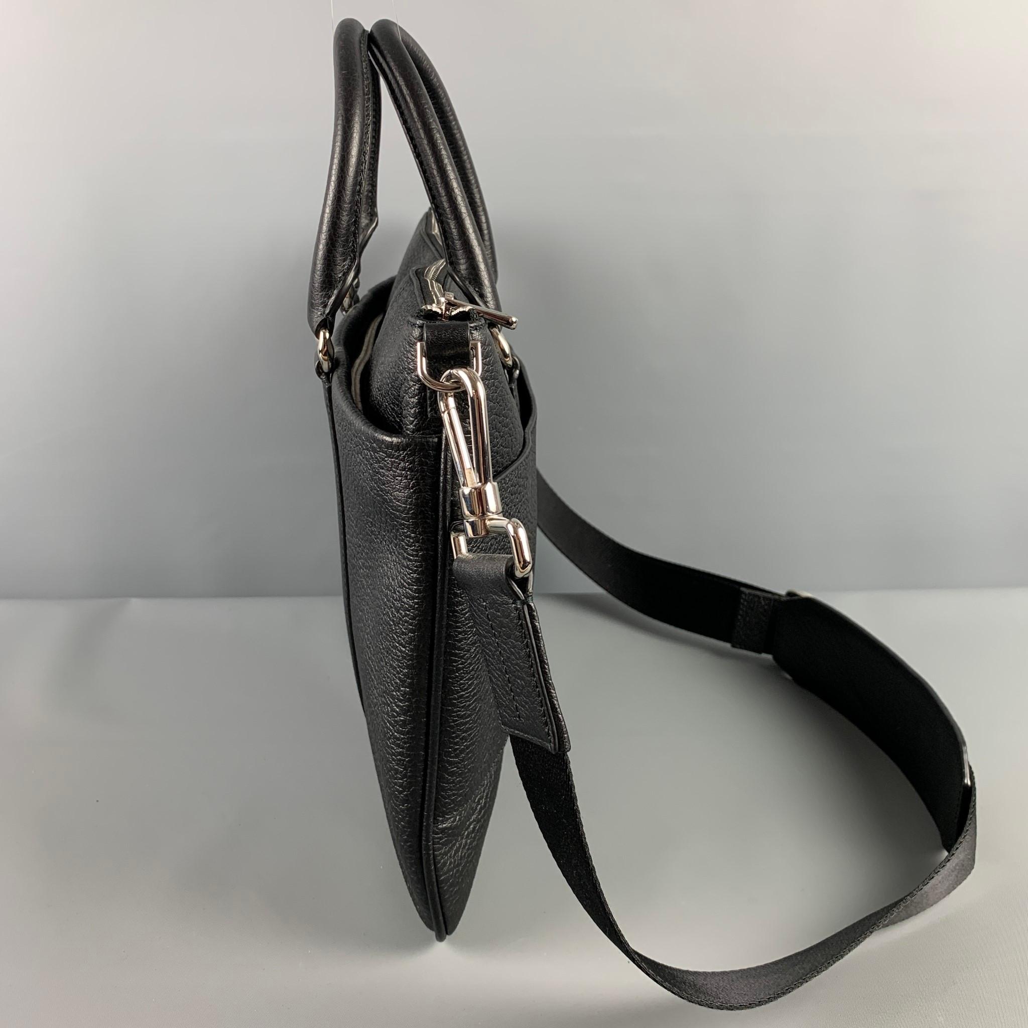 BALLY bag comes in a black pebble grain leather featuring top handles, detachable shoulder strap, silver tone hardware, inner slots, and a zipper closure. Includes tags. 

Excellent Pre-Owned Condition.

Measurements:

Length: 16 in.
Height: 11.25
